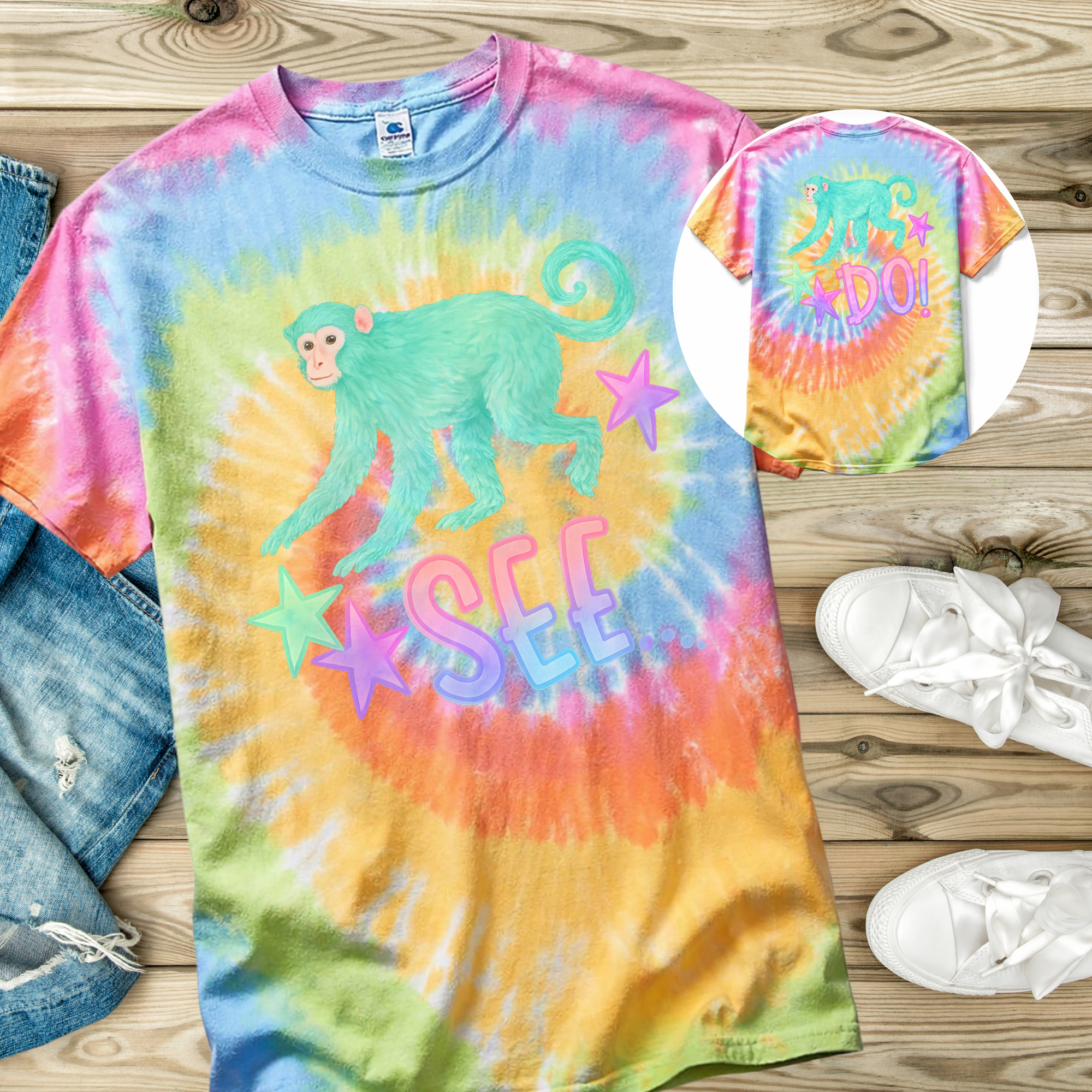Colorful tie-dye t-shirt with a monkey graphic and text on a wooden surface.