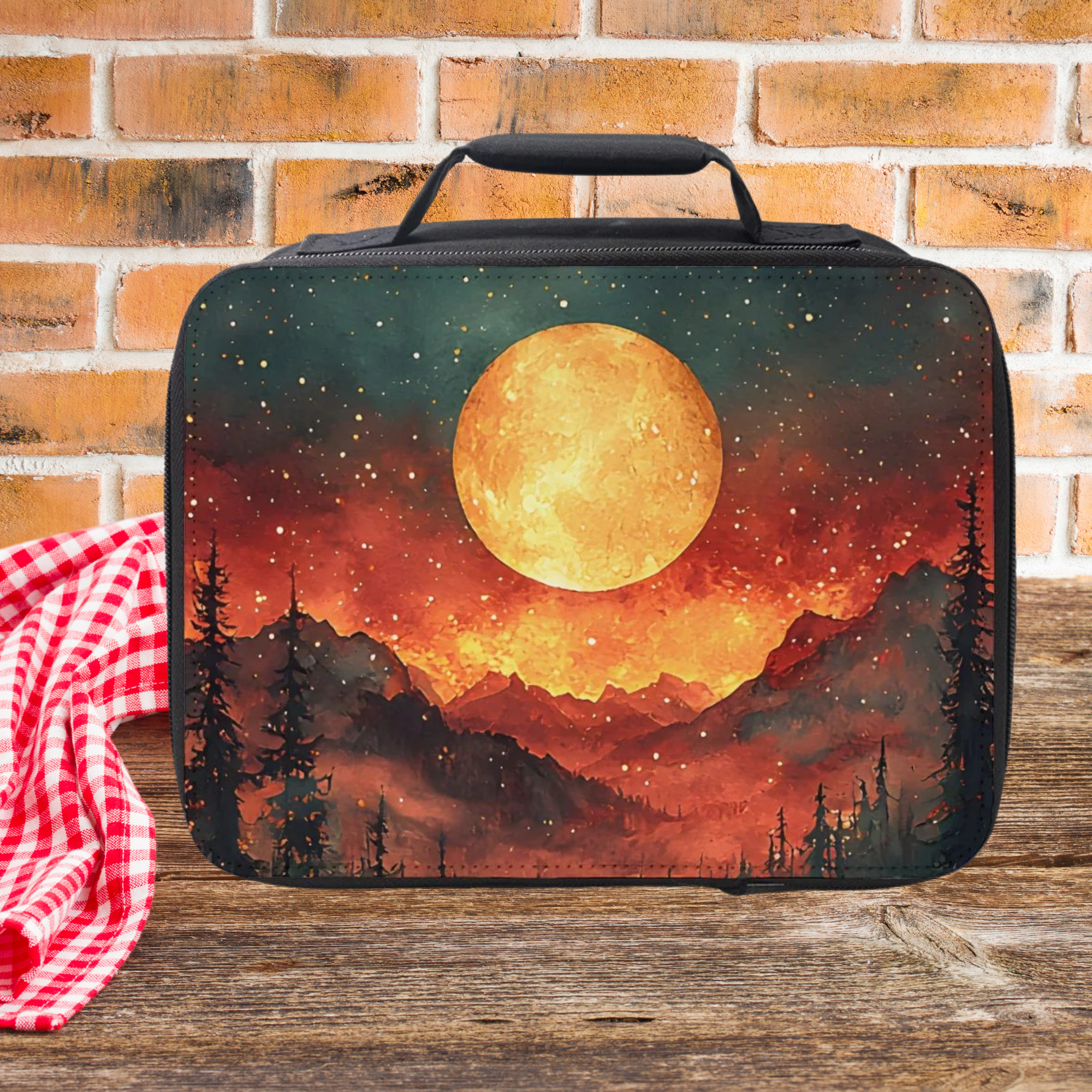  insulated lunch bag with a sunset design on a wooden picnic table and brick wall background