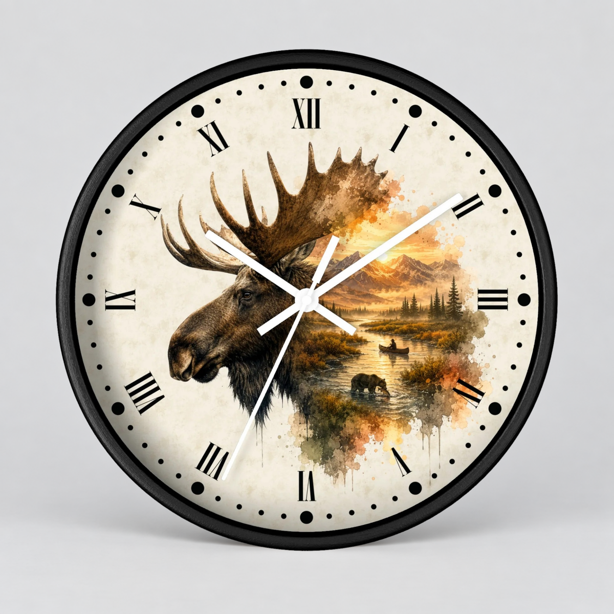A round wall clock with a black frame and a cream-colored face featuring a moose head and a scenic landscape in warm autumn tones. The clock has black Roman numerals and white hands, photographed against a light gray background.