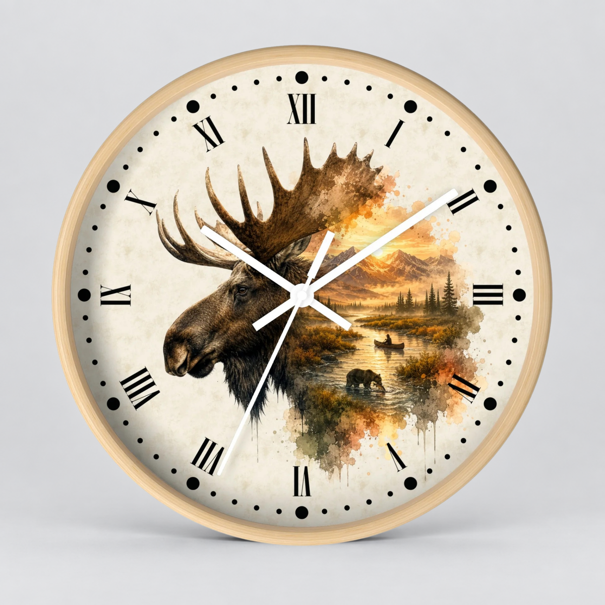 Round wall clock with a light wood frame and a printed moose head over a scenic landscape on the dial, with black Roman numerals and white hands on a light gray background.