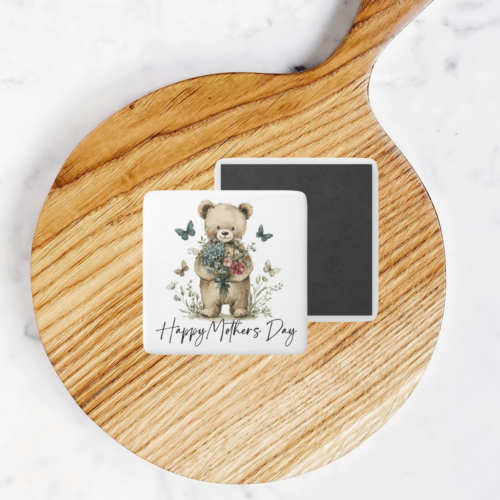 Square magnet with teddy bear and flowers design on a round wooden board.