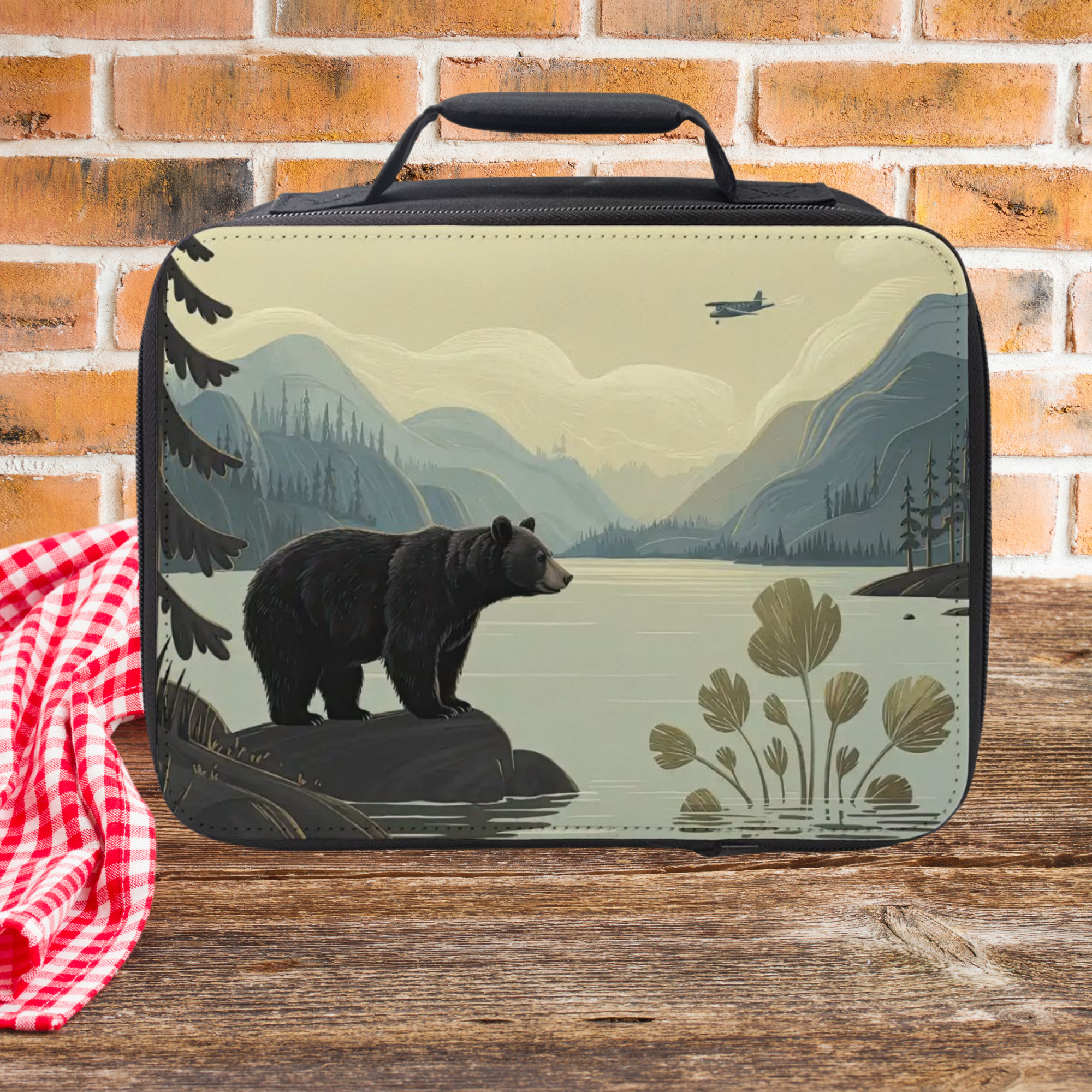 Lunch bag with bear and nature design on a wooden surface and brick wall background