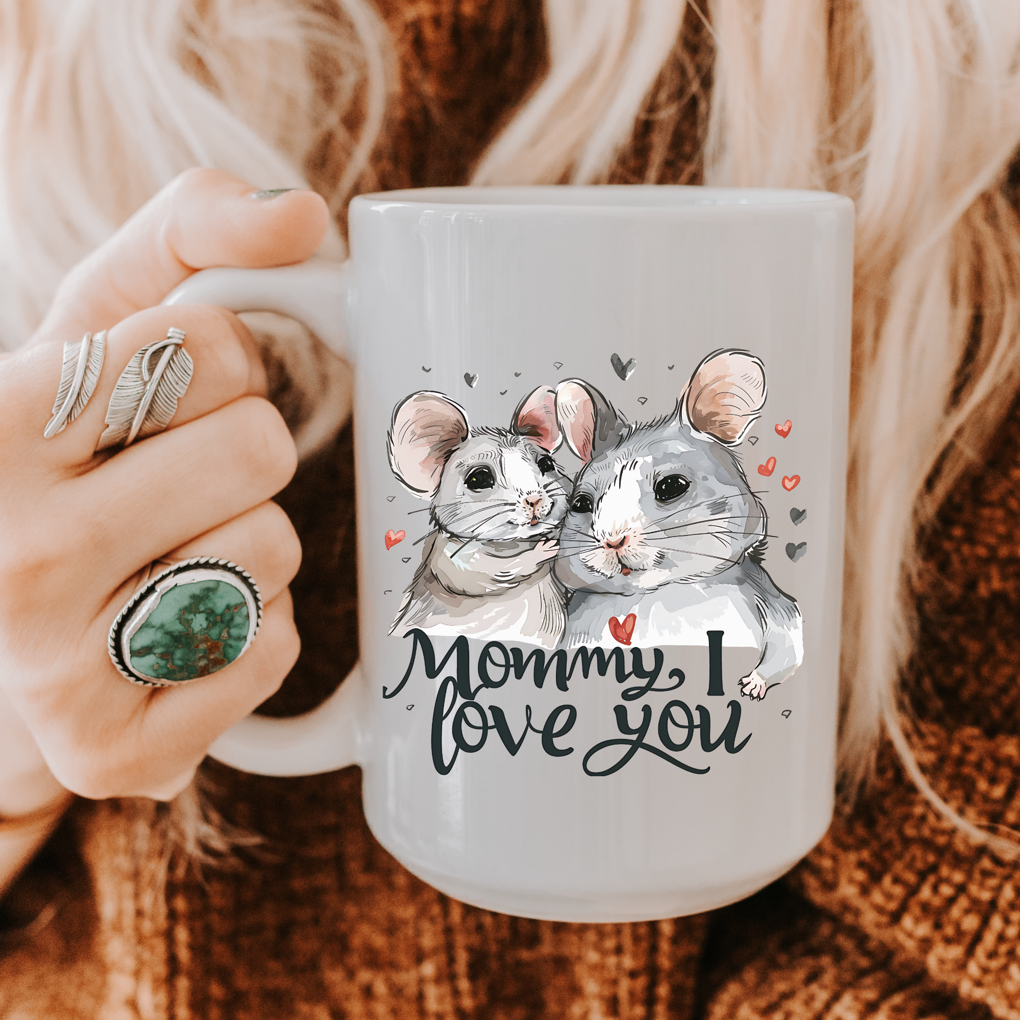 Person holding a mug with mice illustrations and 'Mommy, I love you' text.
