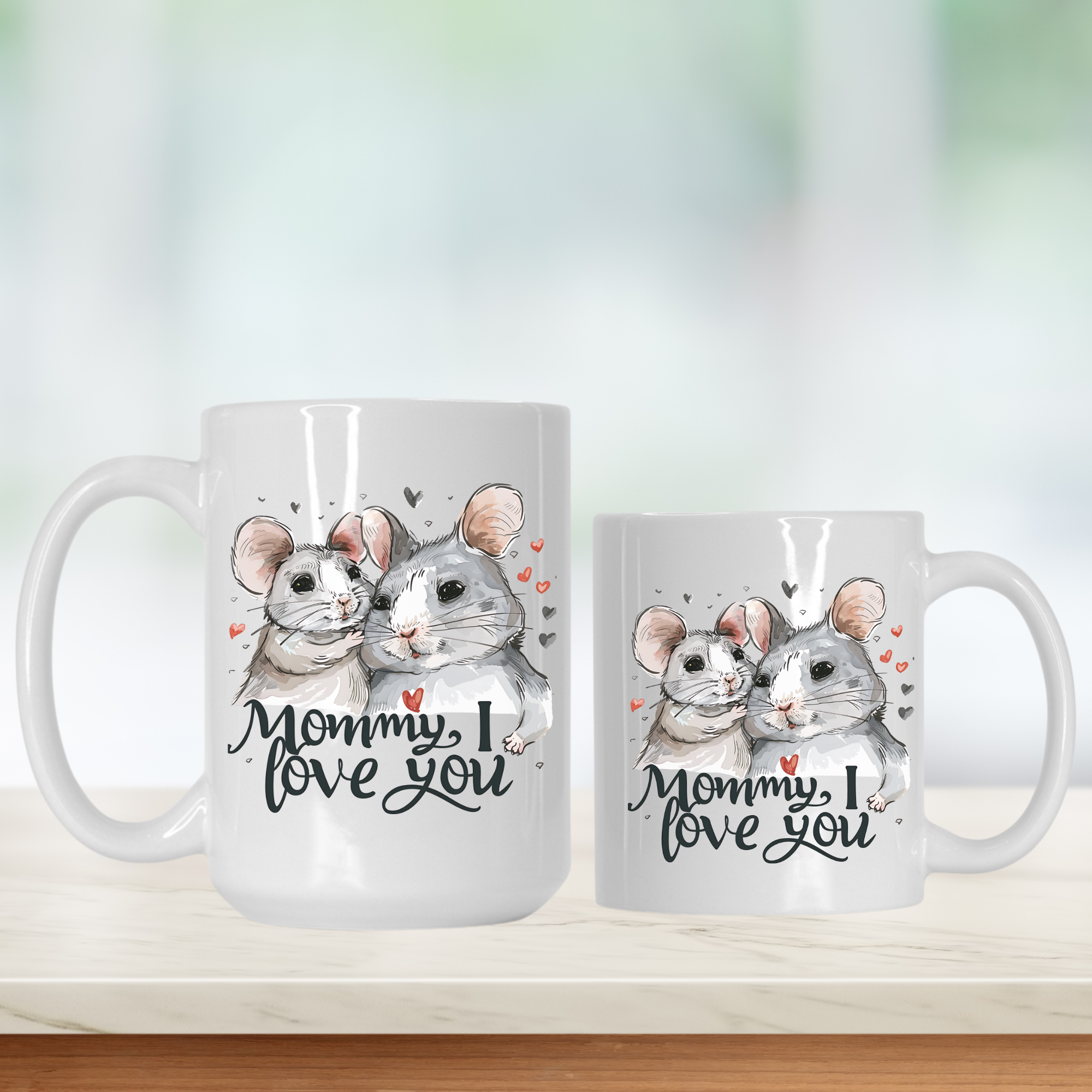 Two mugs with illustrations of two mice and the text 'Mommy, I love you' on a light background.