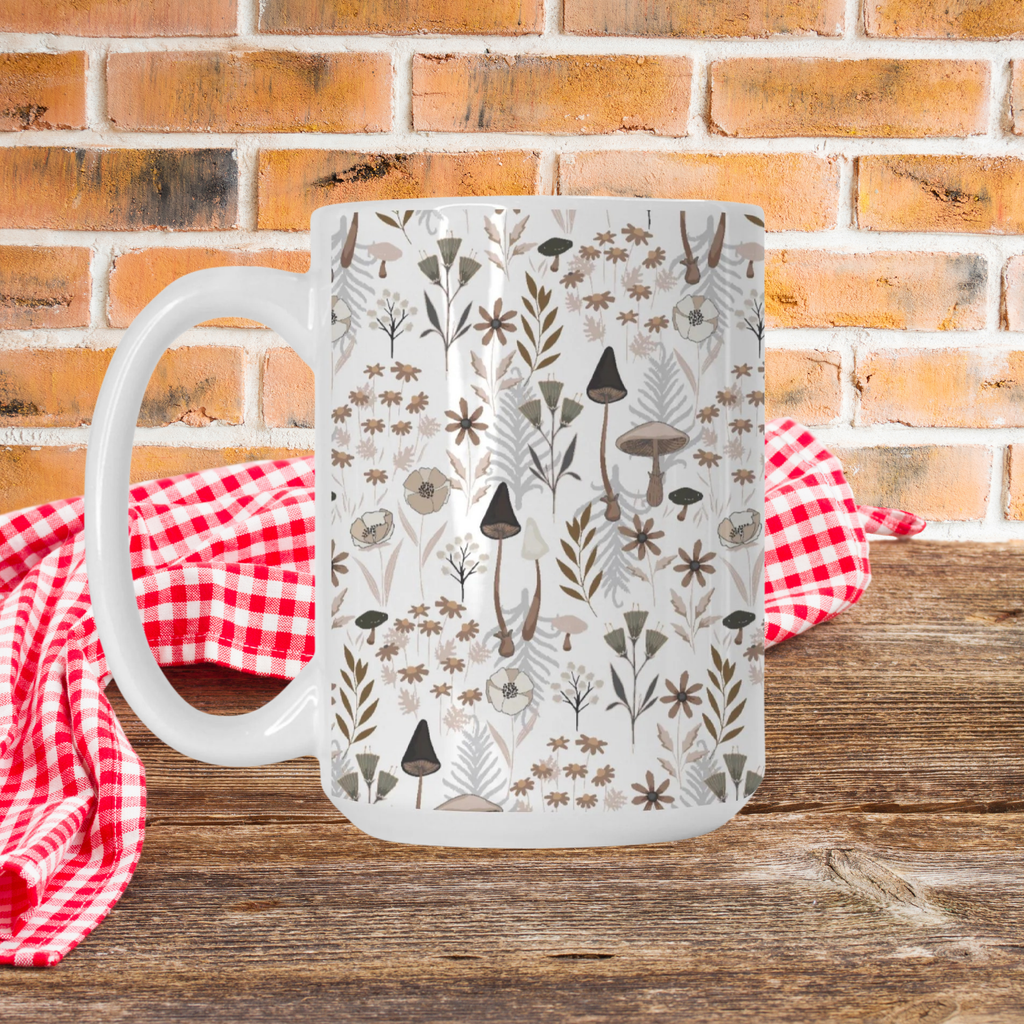 White mug with nature-themed design on a wooden table with a red checkered cloth and brick wall background