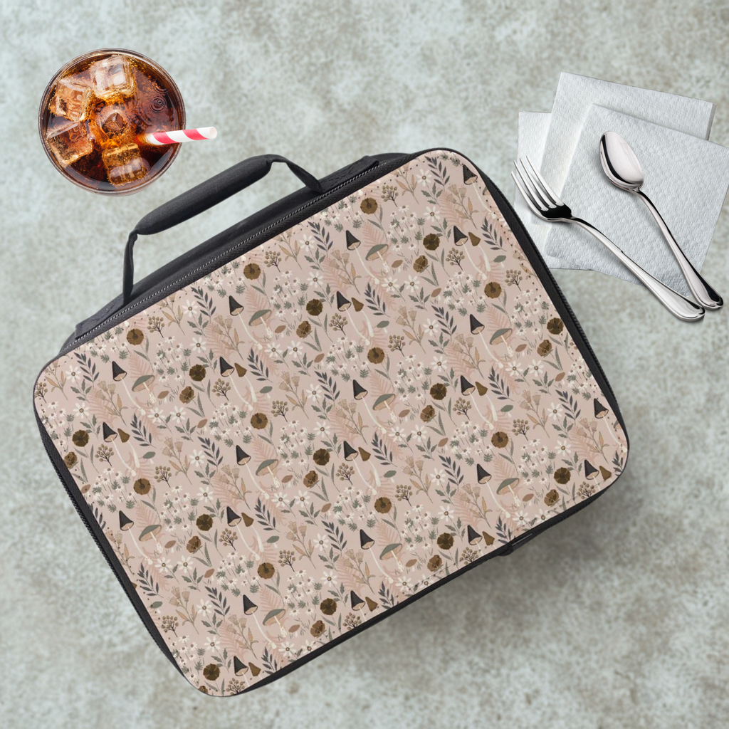 Mushroom & Floral patterned lunch bag on a cafeteria table with a drink and utensils.