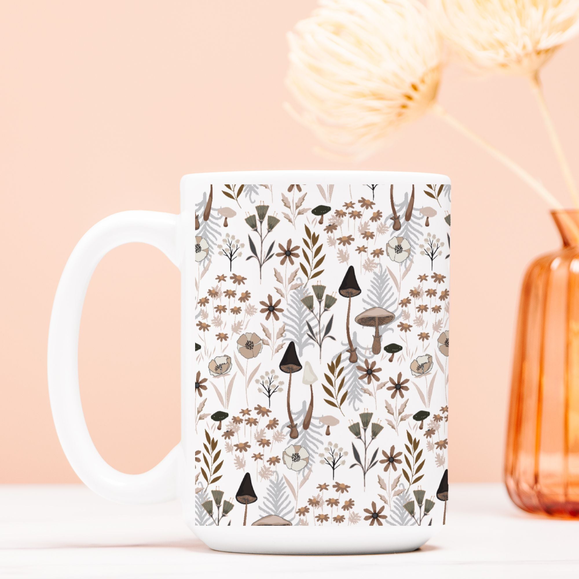 White mug with nature-themed  mushroom floral pattern on a light pink background