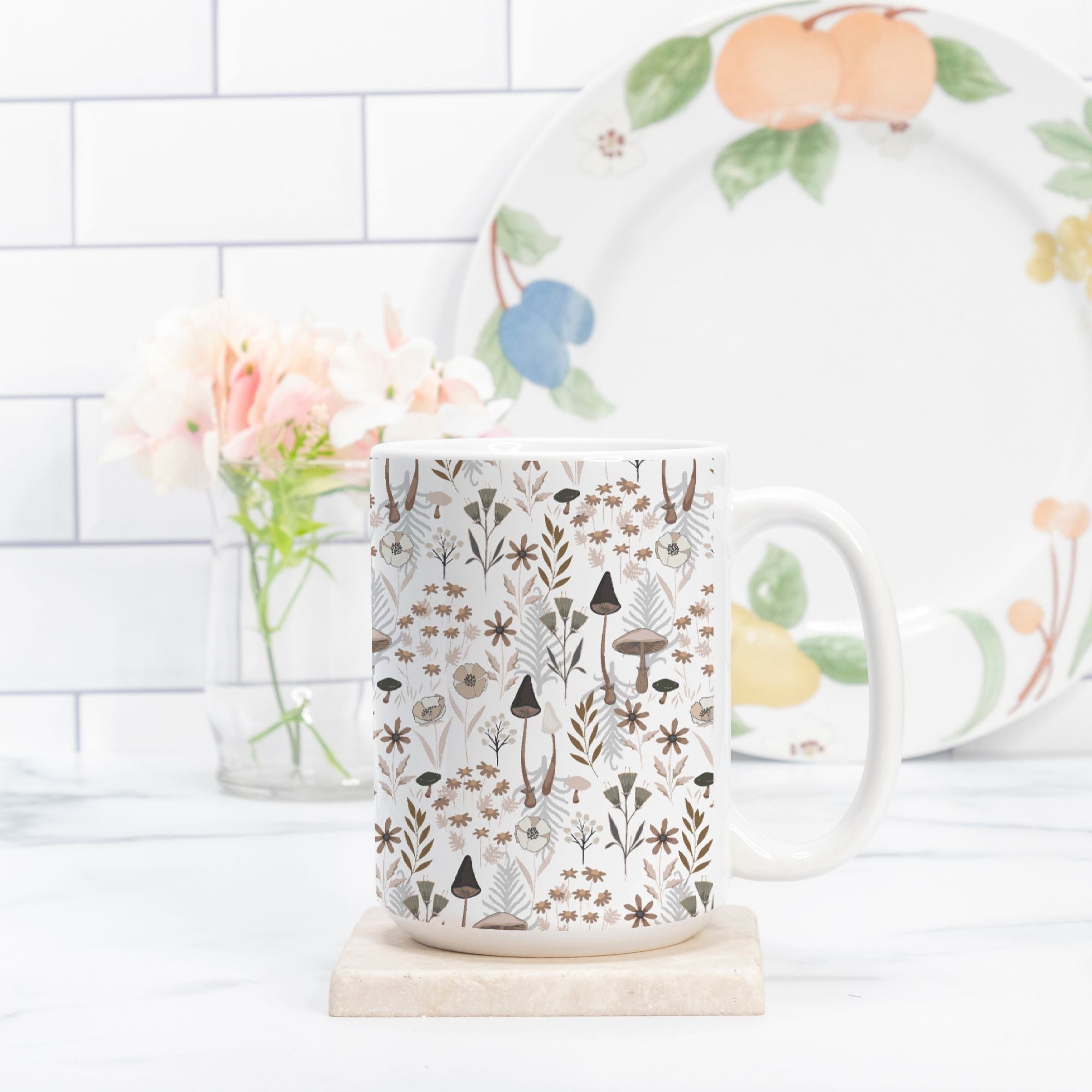 Mug with nature-themed mushroom floral design on a marble surface with a blurred background