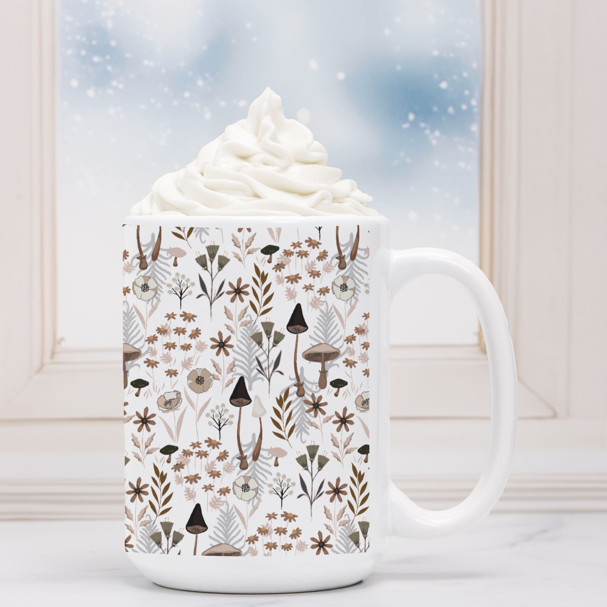 Mug with nature-themed design filled with hot chocolate and whipped cream.