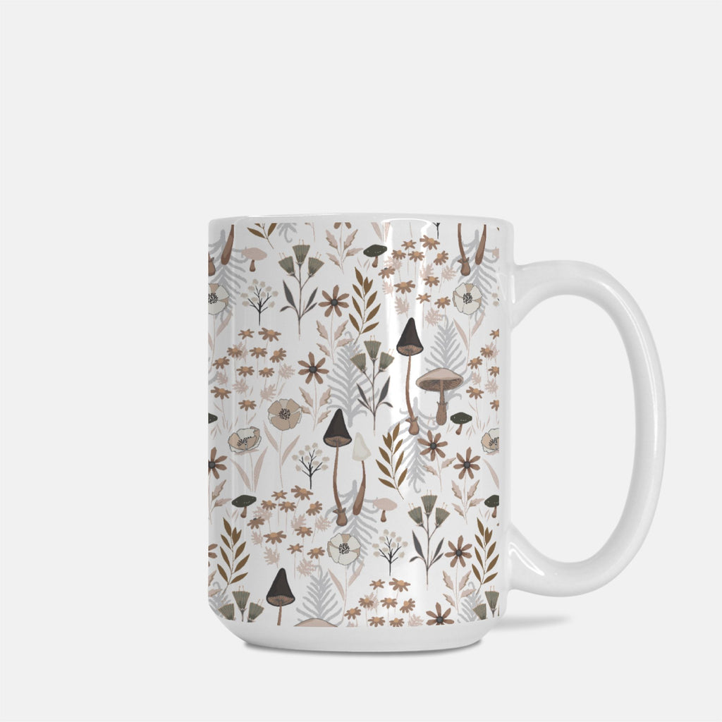 White mug with a nature-themed pattern featuring plants and mushrooms on a white background