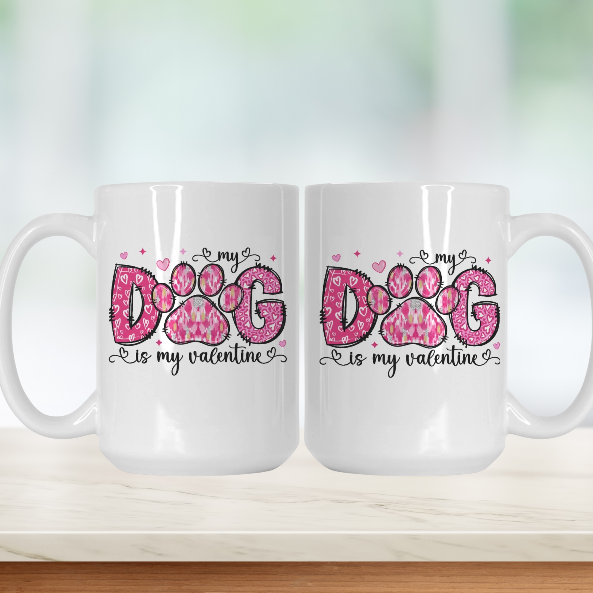 Two white mugs with pink paw print design and text on a light background