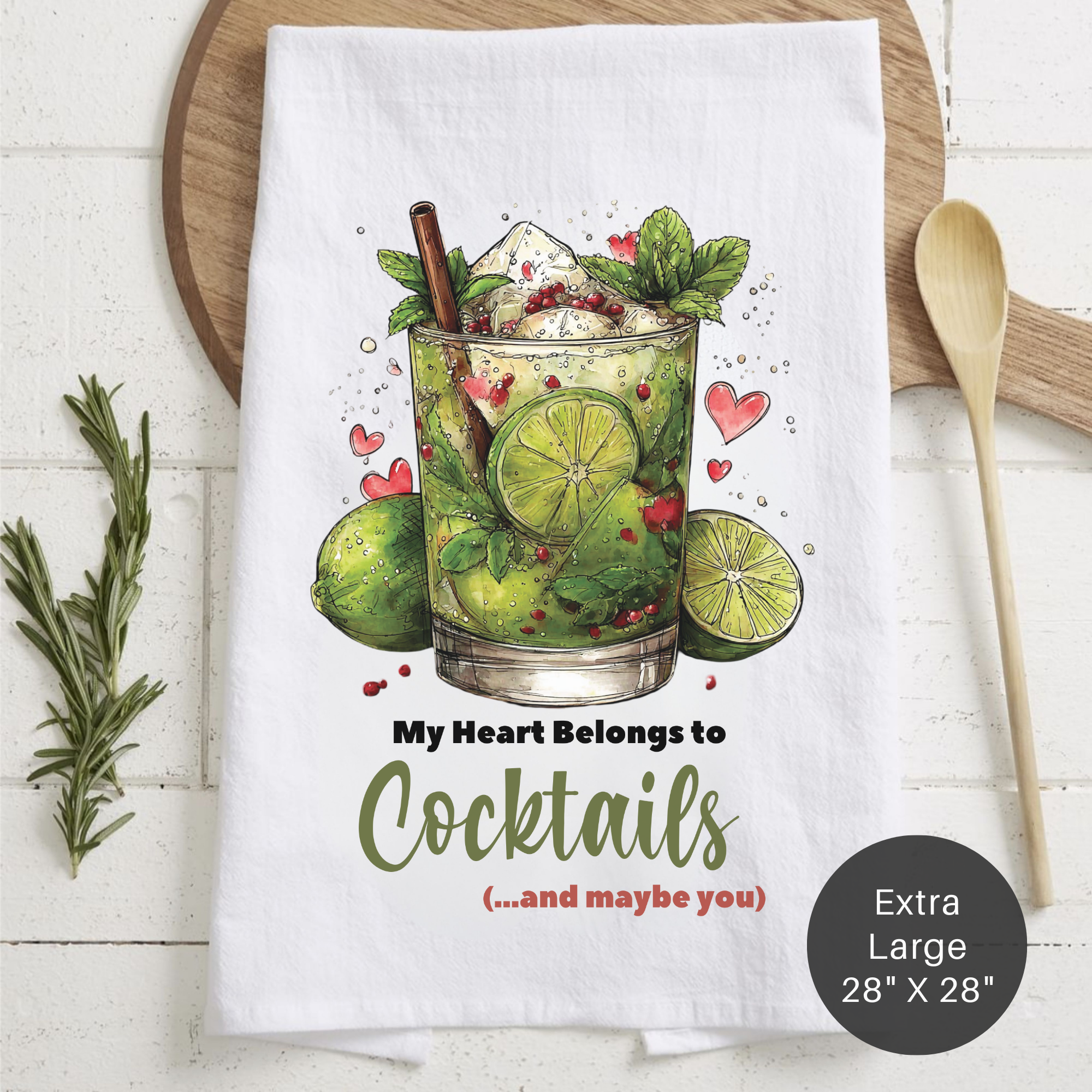 Tea towel with cocktail illustration and text on a wooden surface
