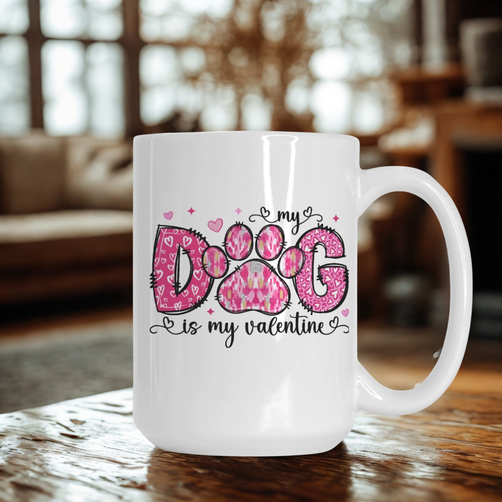 White mug with pink paw design and text on a wooden table