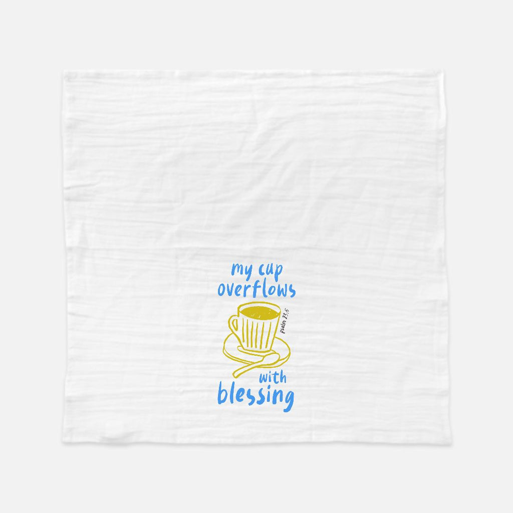 White towel with a yellow teacup graphic and blue text on a white background
