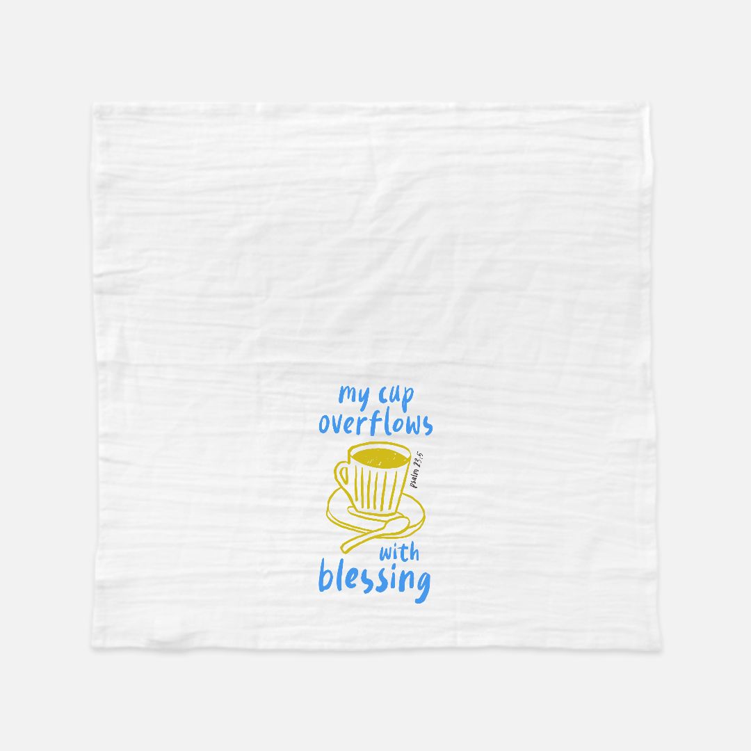 White towel with a yellow teacup graphic and blue text on a white background