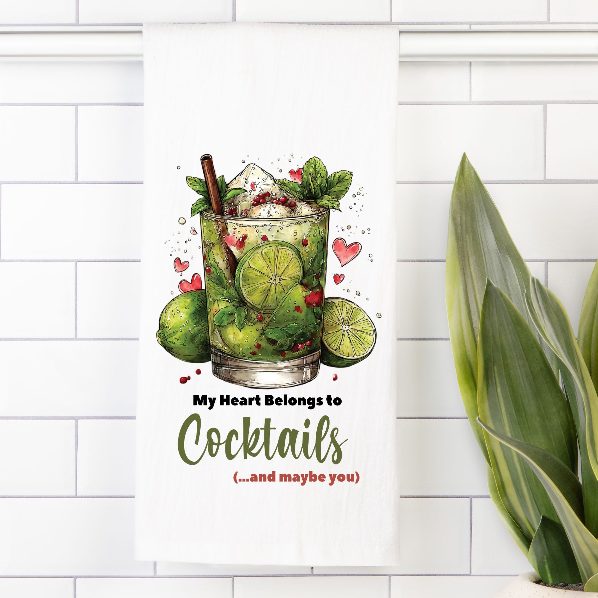 Decorative tea towel with a cocktail illustration and text 'My Heart Belongs To Cocktails (...and maybe you)' on a white tiled wall.