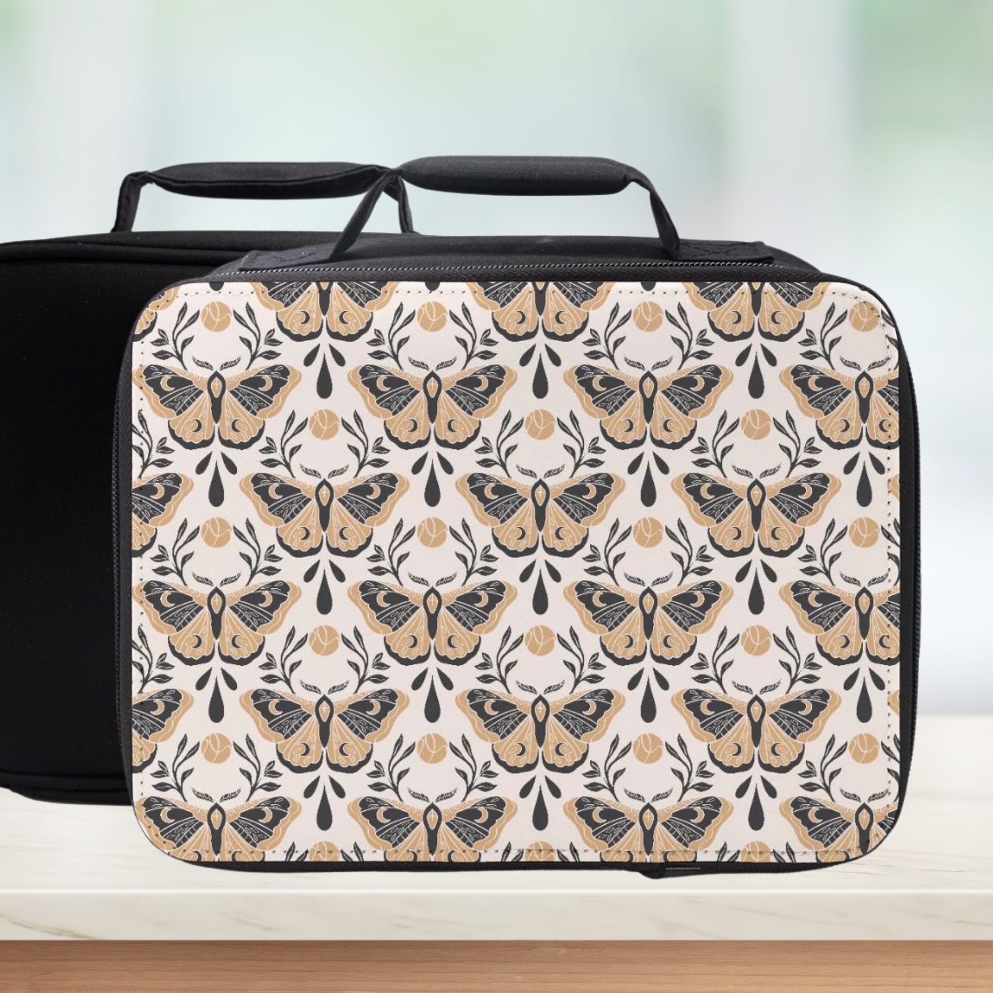 Black suitcase with butterfly pattern on a light background