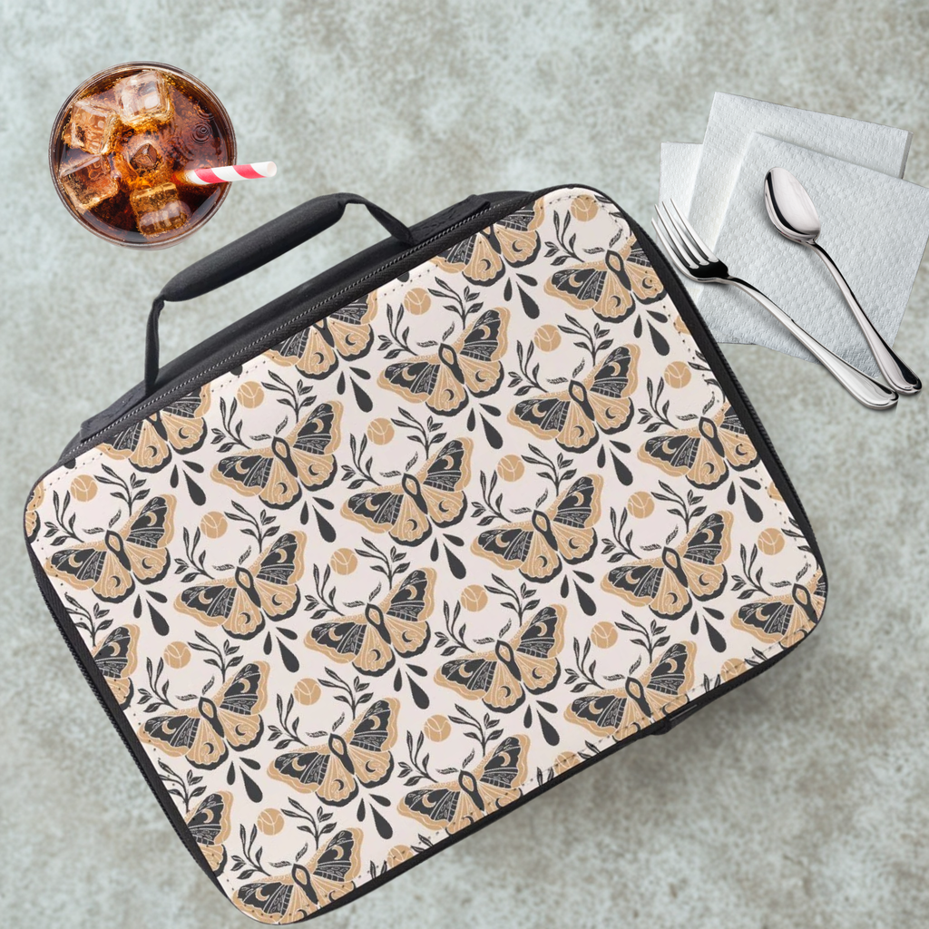 Moth-patterned lunch bag on a cafeteria table with a drink and utensils.