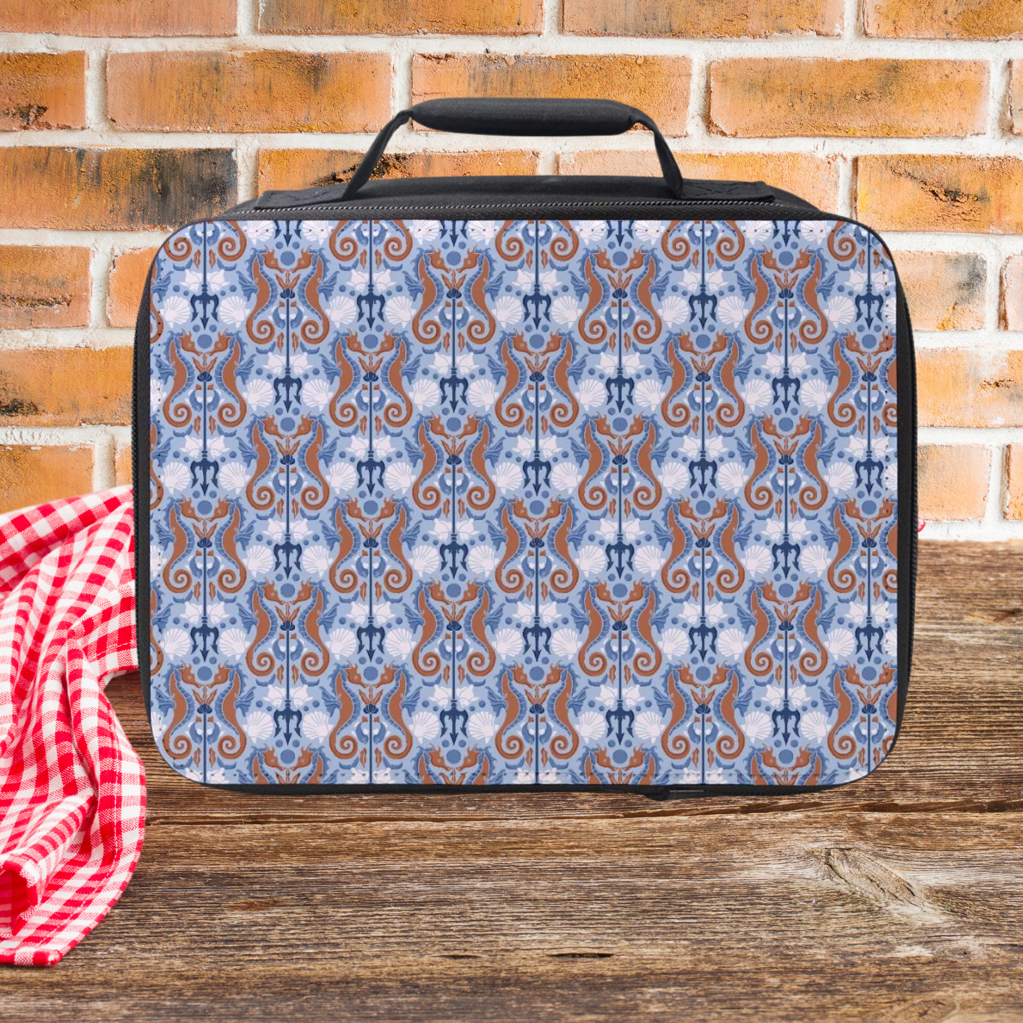 Seahorse patterned lunch bag on a wooden surface with a brick wall background