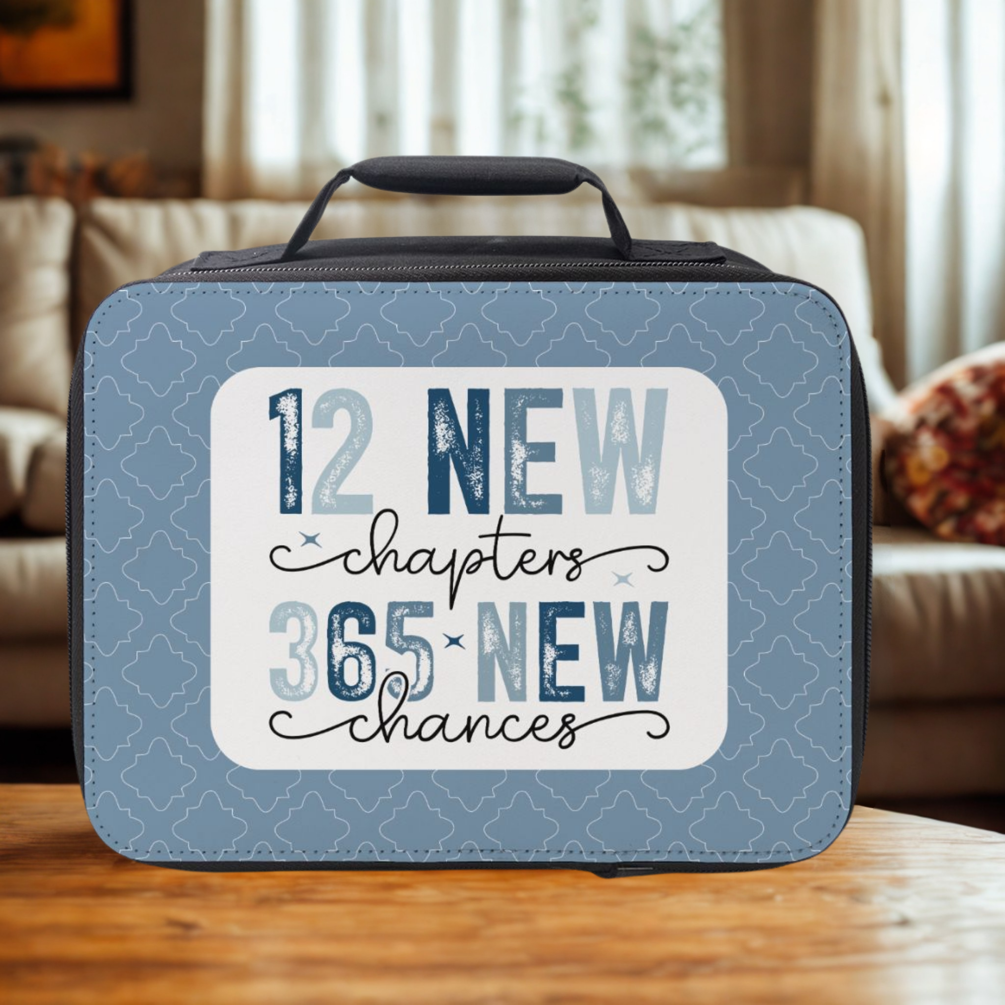 Blue insulated lunch bag with motivational quote on a wooden coffee table