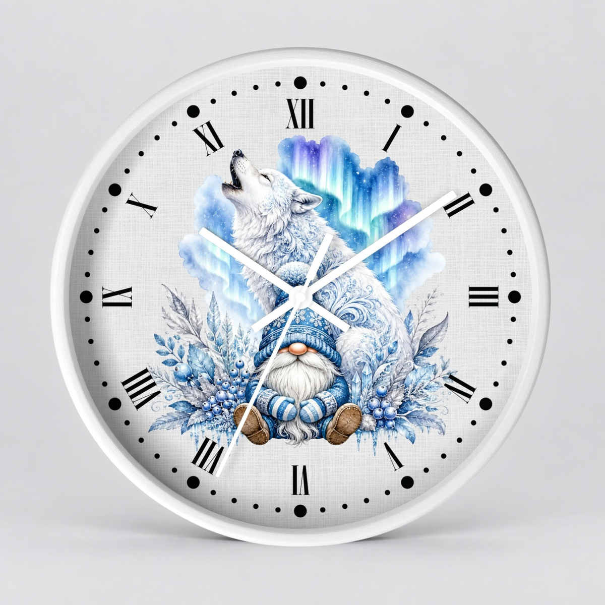 A round wall clock with a white frame and a detailed illustration on the face showing a white wolf howling above a blue-and-white gnome surrounded by winter foliage and aurora-like blue clouds. The clock uses black Roman numerals and black dot hour markers on a light gray background.