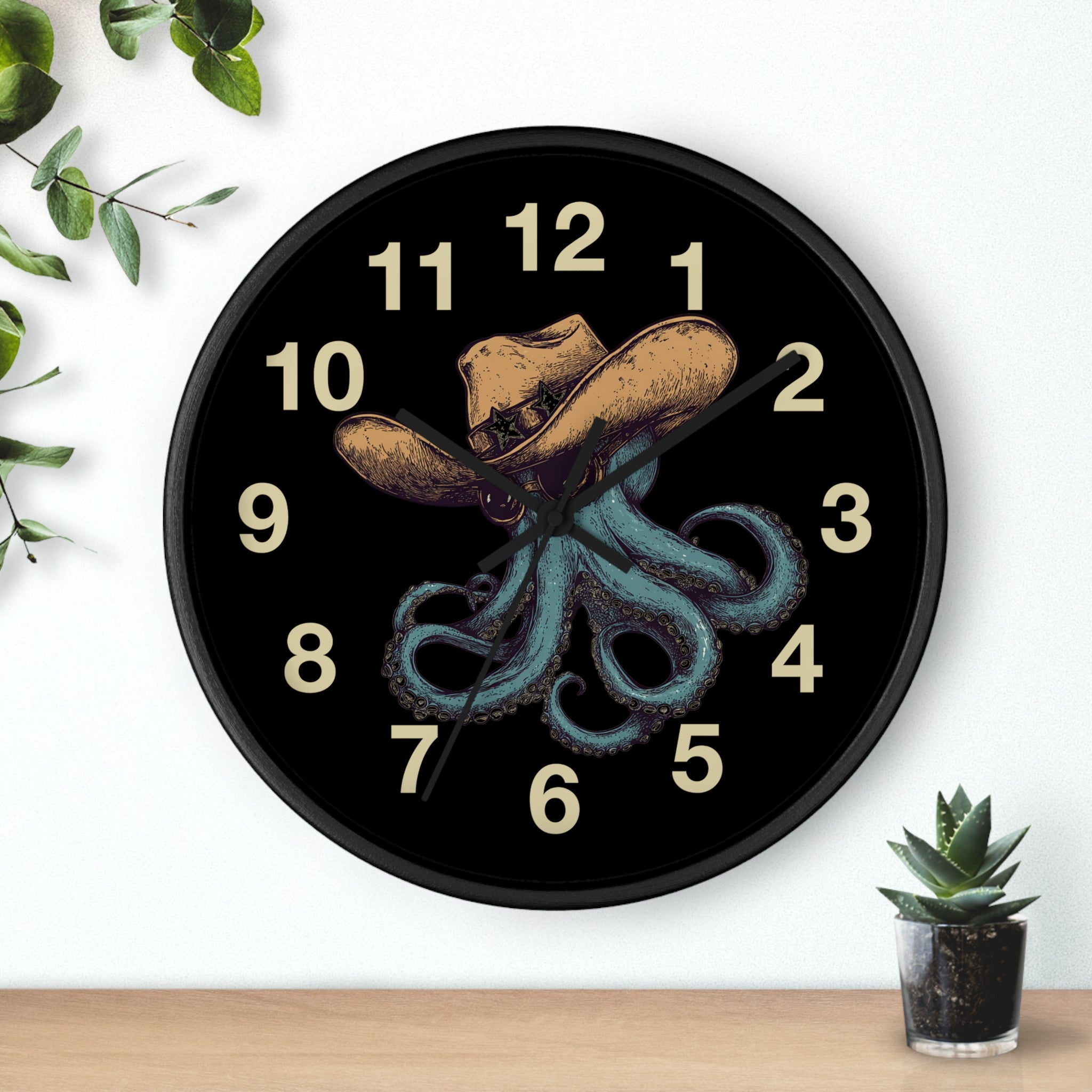 Black Wall clock with black hands and a design of an octopus wearing a cowboy hat and sun glasses on a black background.