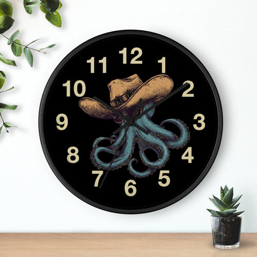 Black Wall clock with black hands and a design of an octopus wearing a cowboy hat and sun glasses on a black background.