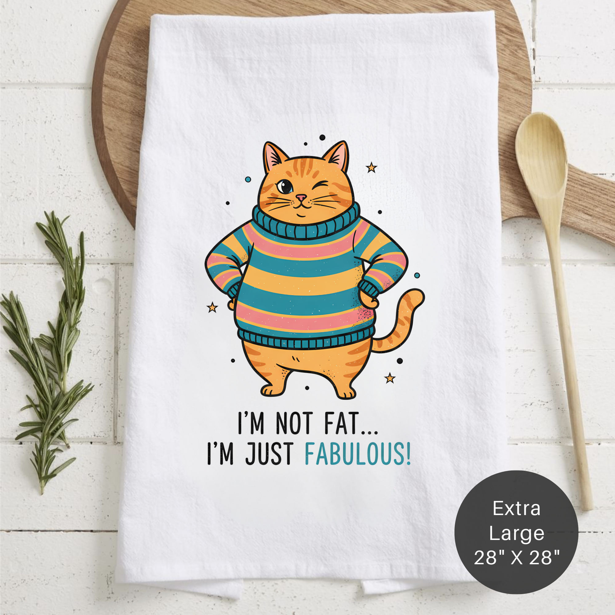 Tea towel with a cat in a sweater design and text on a wooden board.