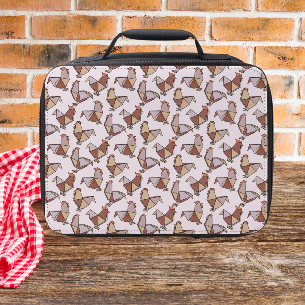 Origami chicken patterned lunch bag on a wooden picnic table with a brick wall background