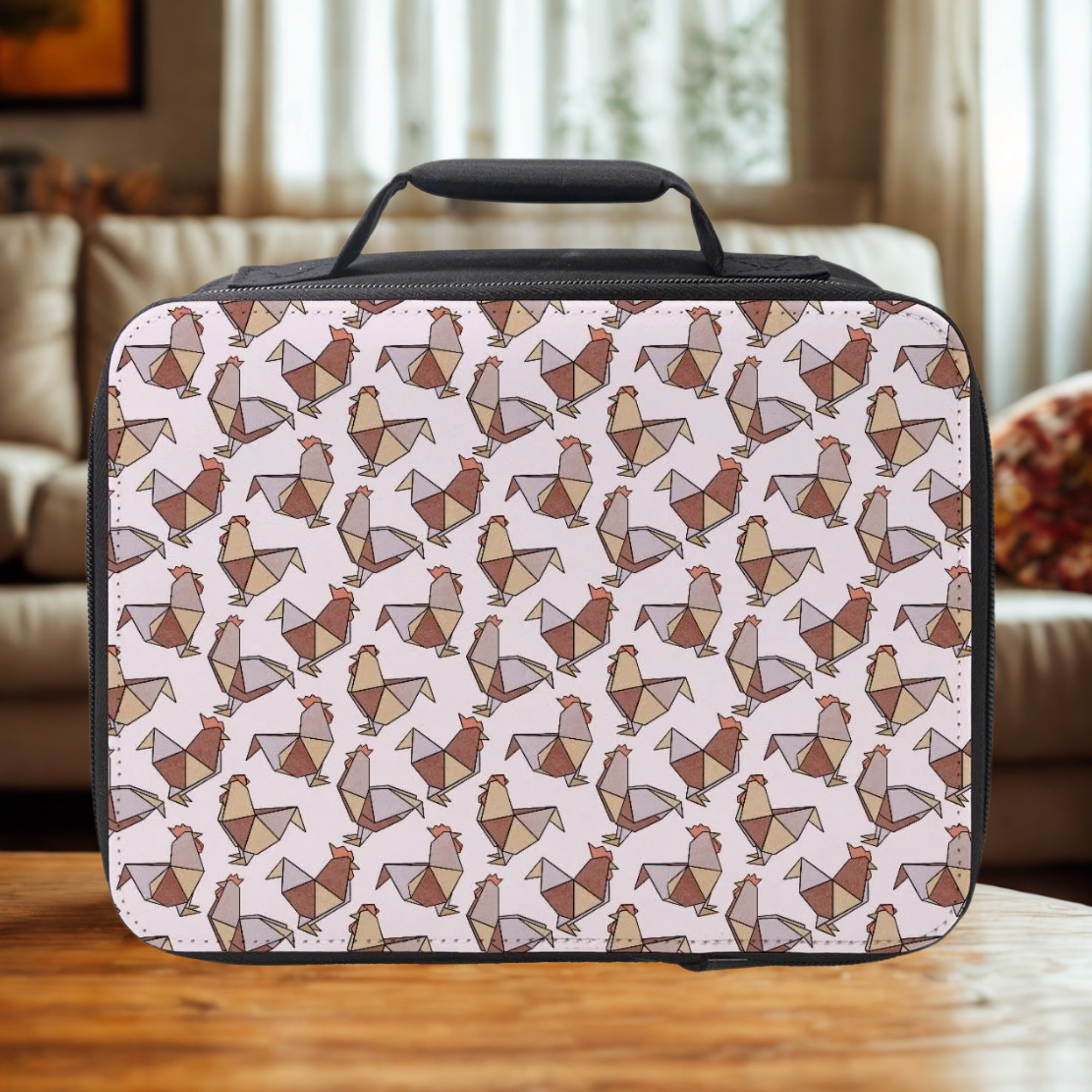 Rectangular lunch box with geometric origami chicken pattern on a wooden living room table.