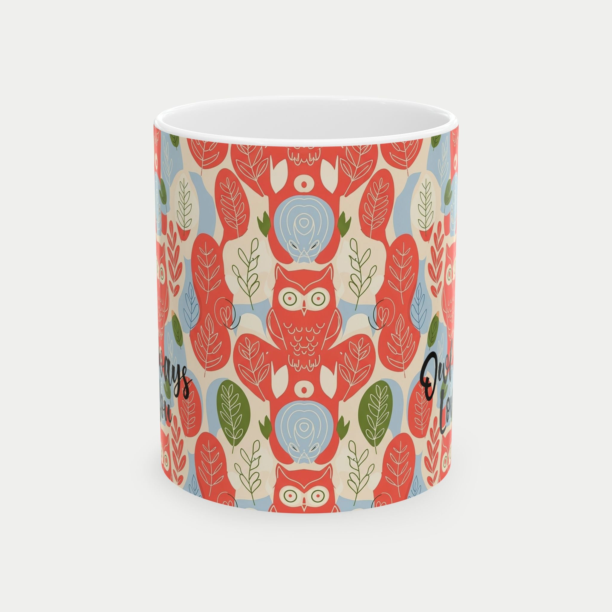 Ceramic mug with a colorful owl and leaf pattern on a white background