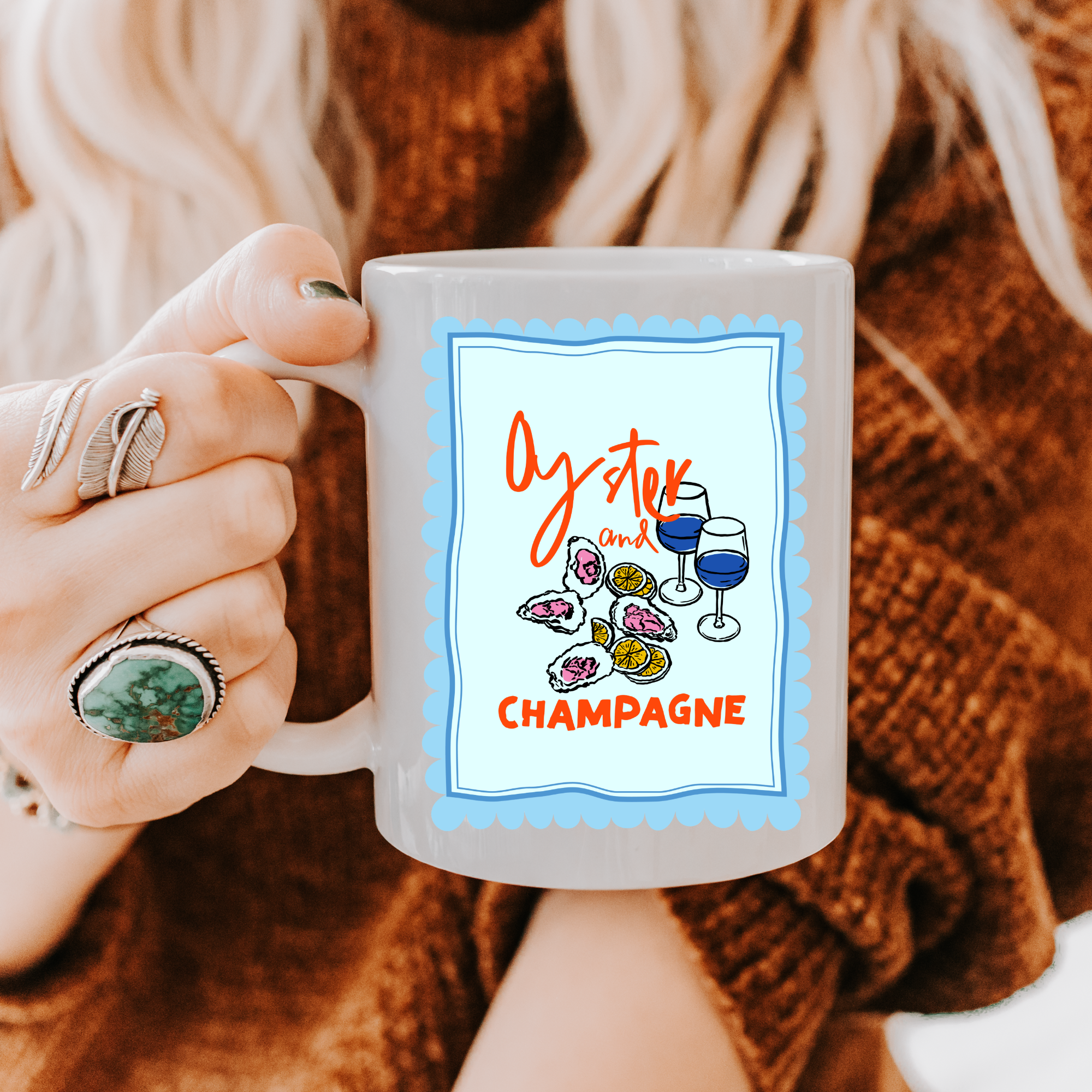 Person holding a 11oz. mug with 'Oyster and Champagne' design