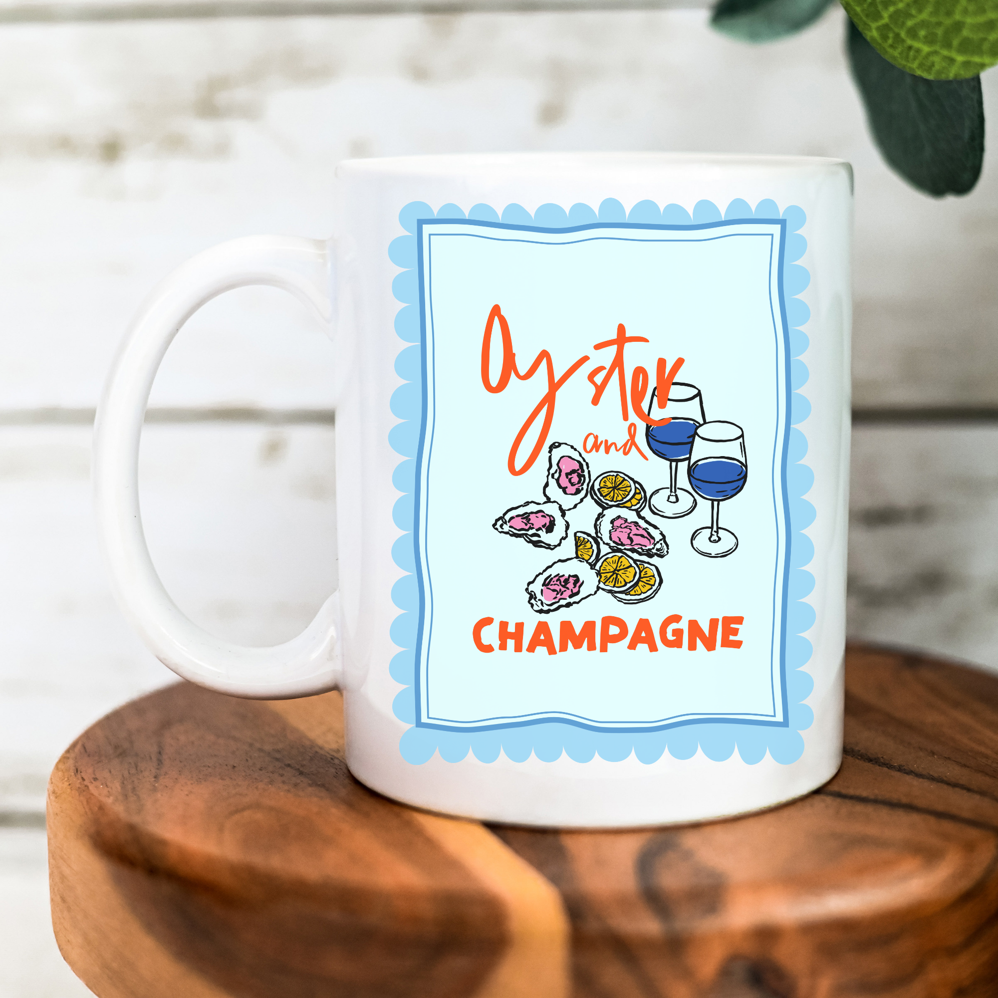 White 11oz. mug with 'Oysters and Champagne' design on a wooden surface