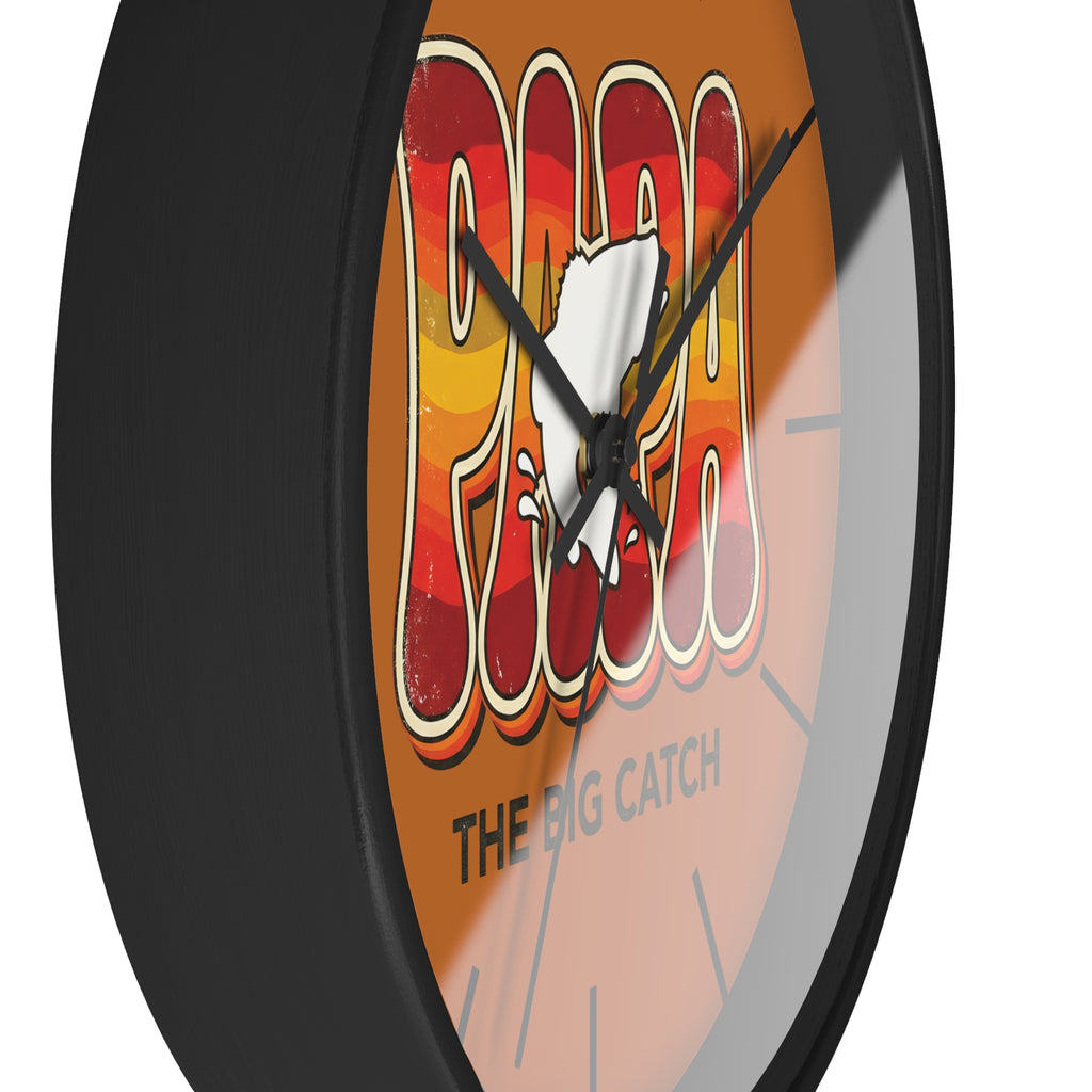 Side view of a round black wall clock with a cartoon character fish and text on an orange background