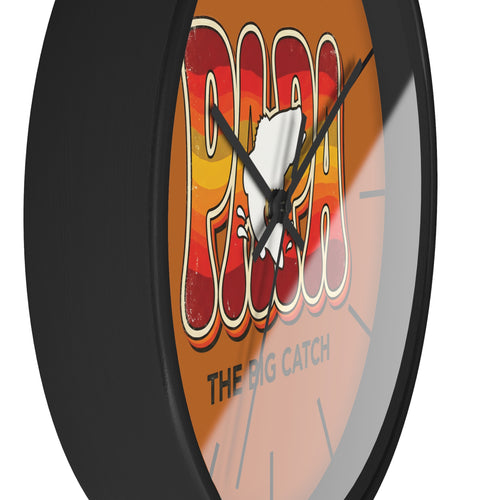 Side view of a round black wall clock with a cartoon character fish and text on an orange background