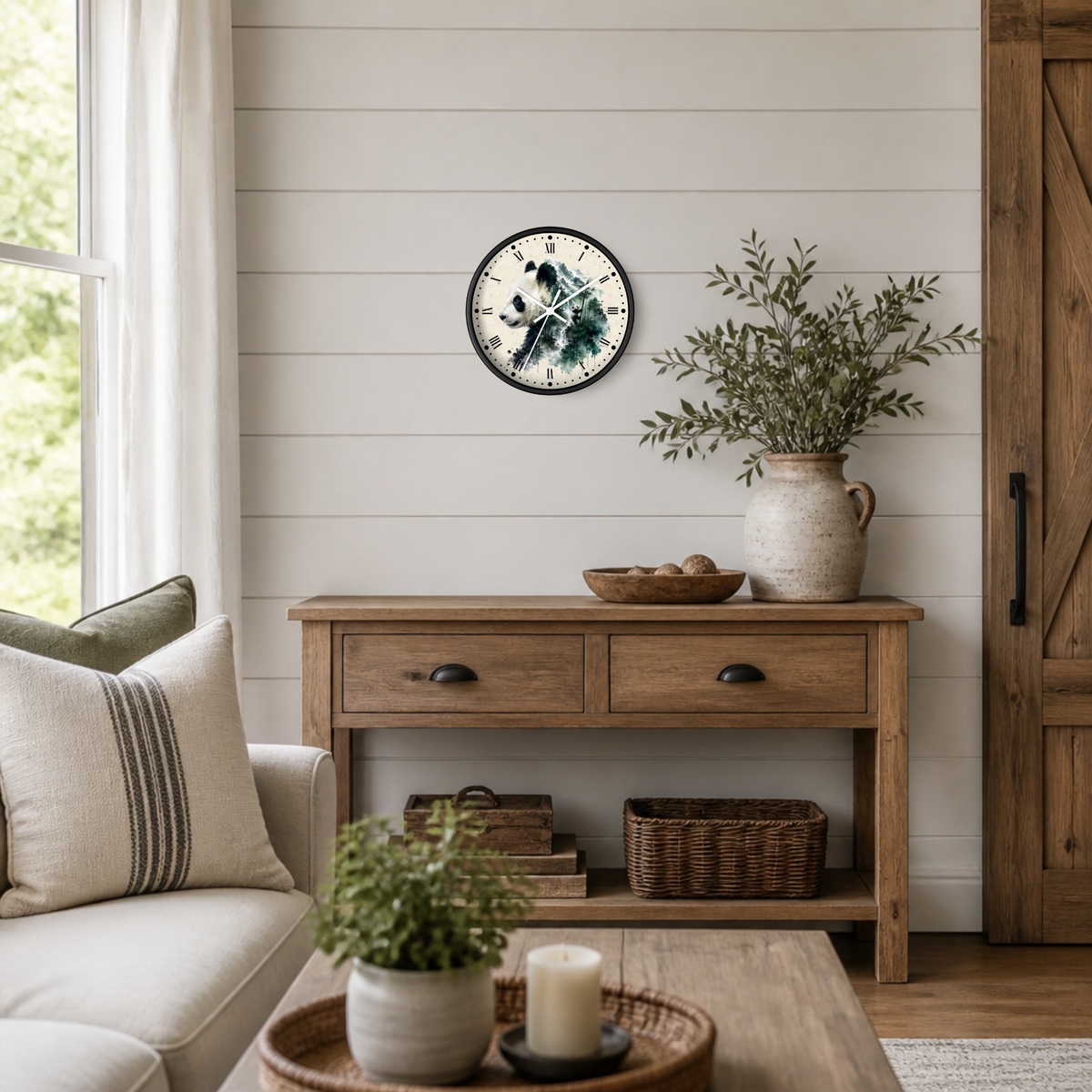 A round wall clock with a rustic illustration of a panda bear on the face, styled on a white shiplap wall above a wooden console table in a bright, modern farmhouse living room.