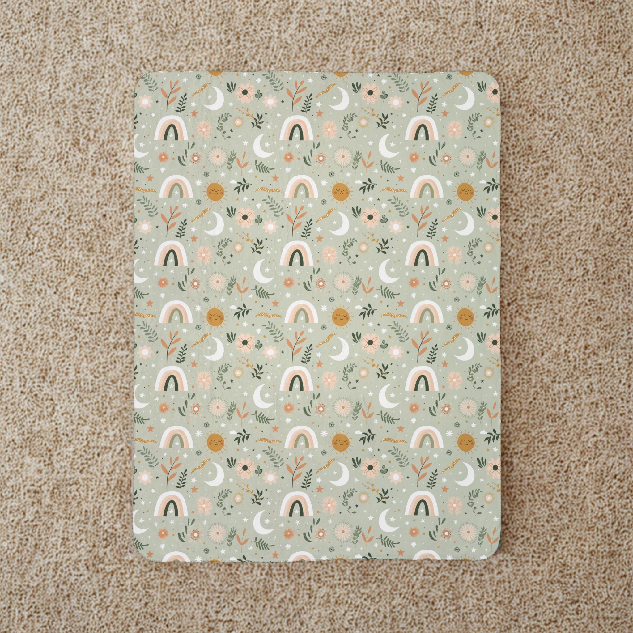 Decorative blanket with rainbow and nature pattern on a beige carpet