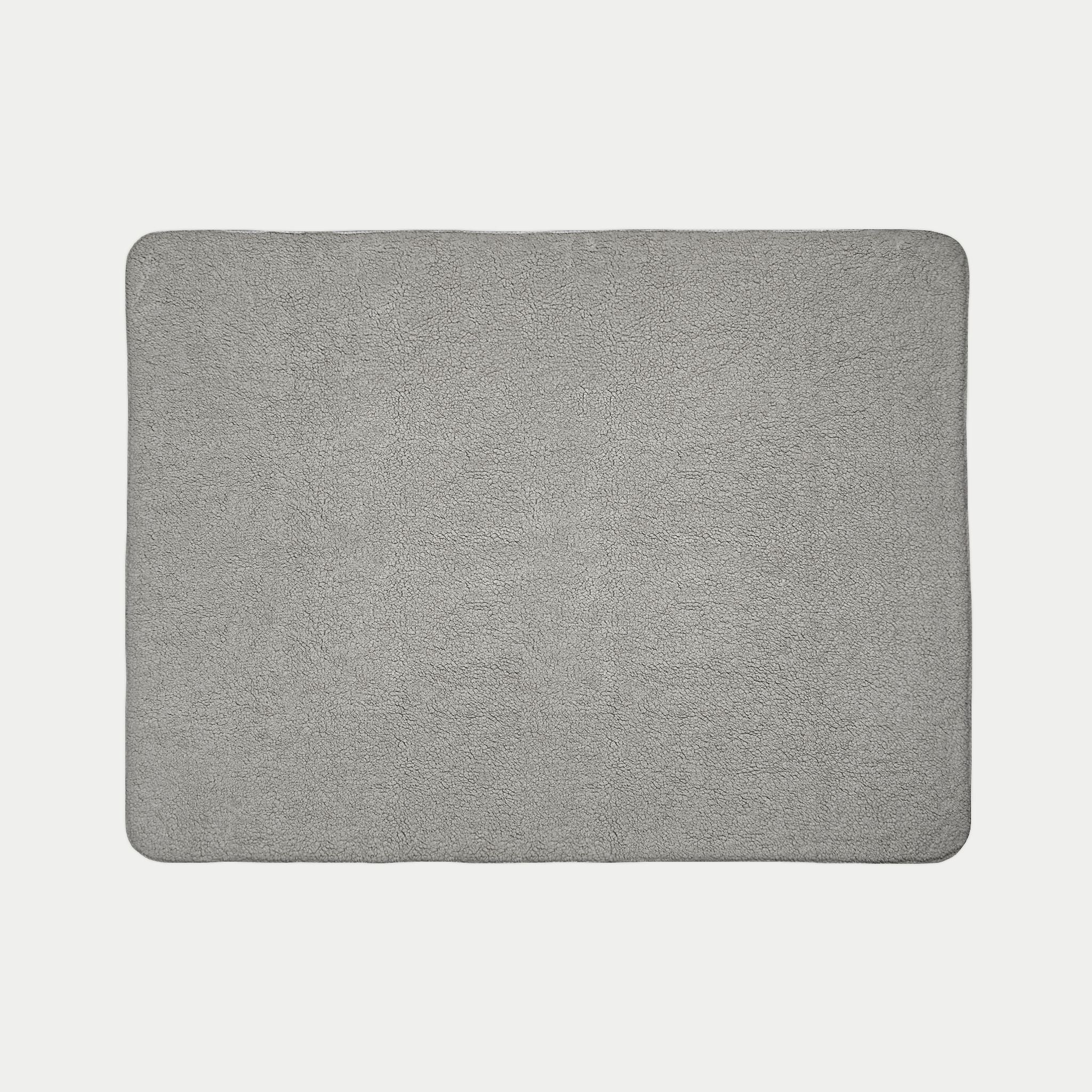 Gray rectangular blanket on a light gray background