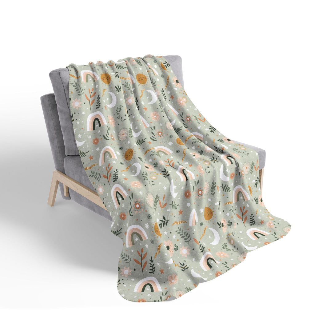 Floral Rainbow patterned blanket draped over a chair on a white background