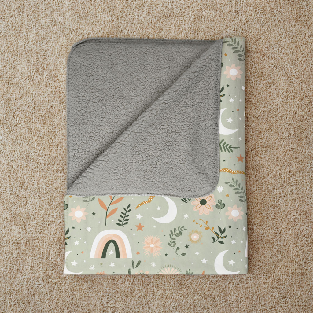 Gray hooded towel with floral pattern on a beige carpet