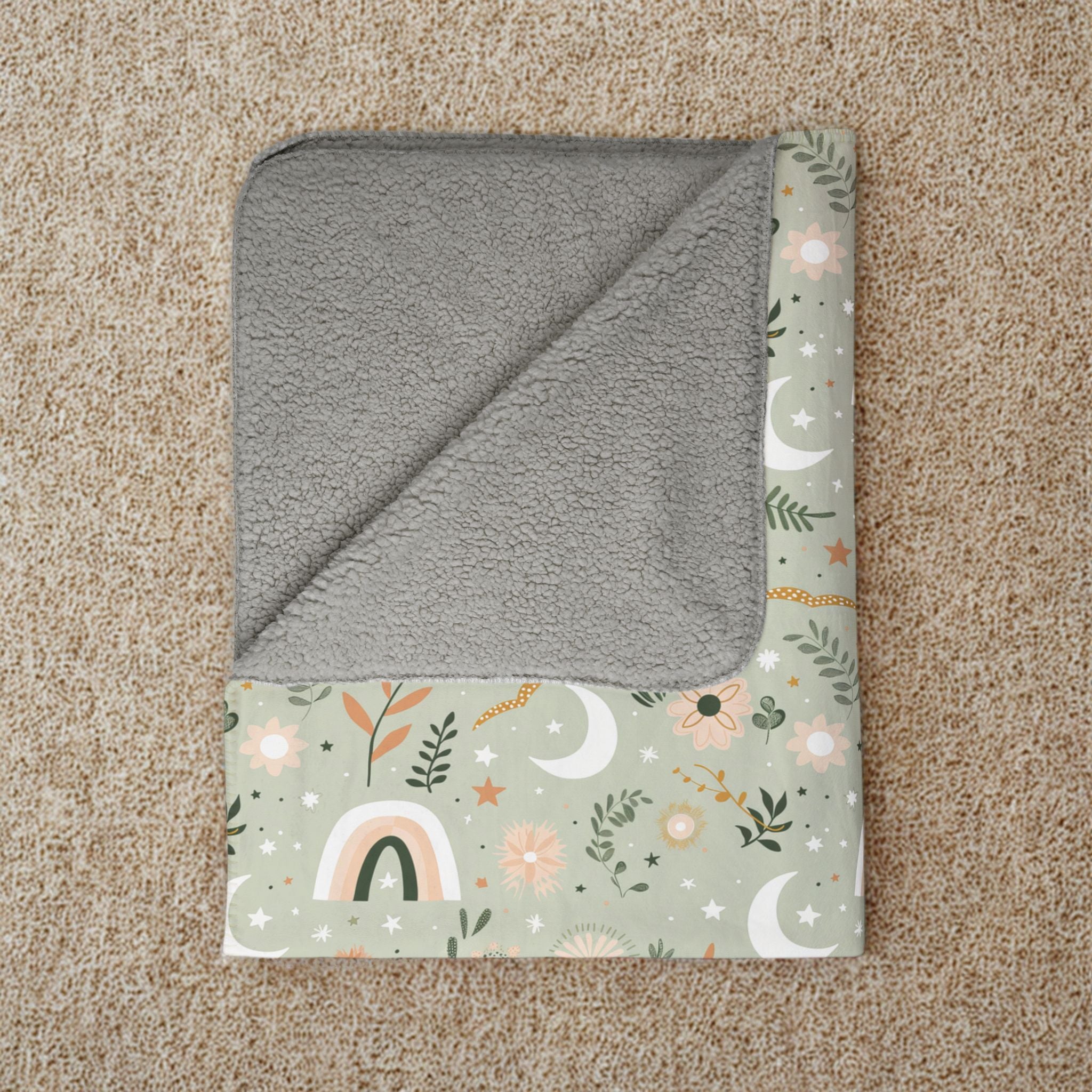 Gray hooded towel with floral pattern on a beige carpet
