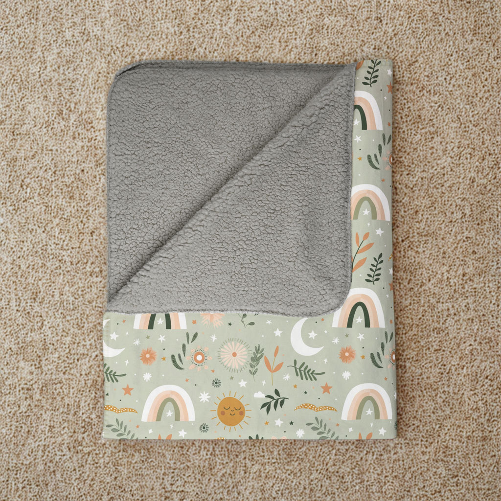 Folded blanket with gray backing and colorful pattern on a beige carpet