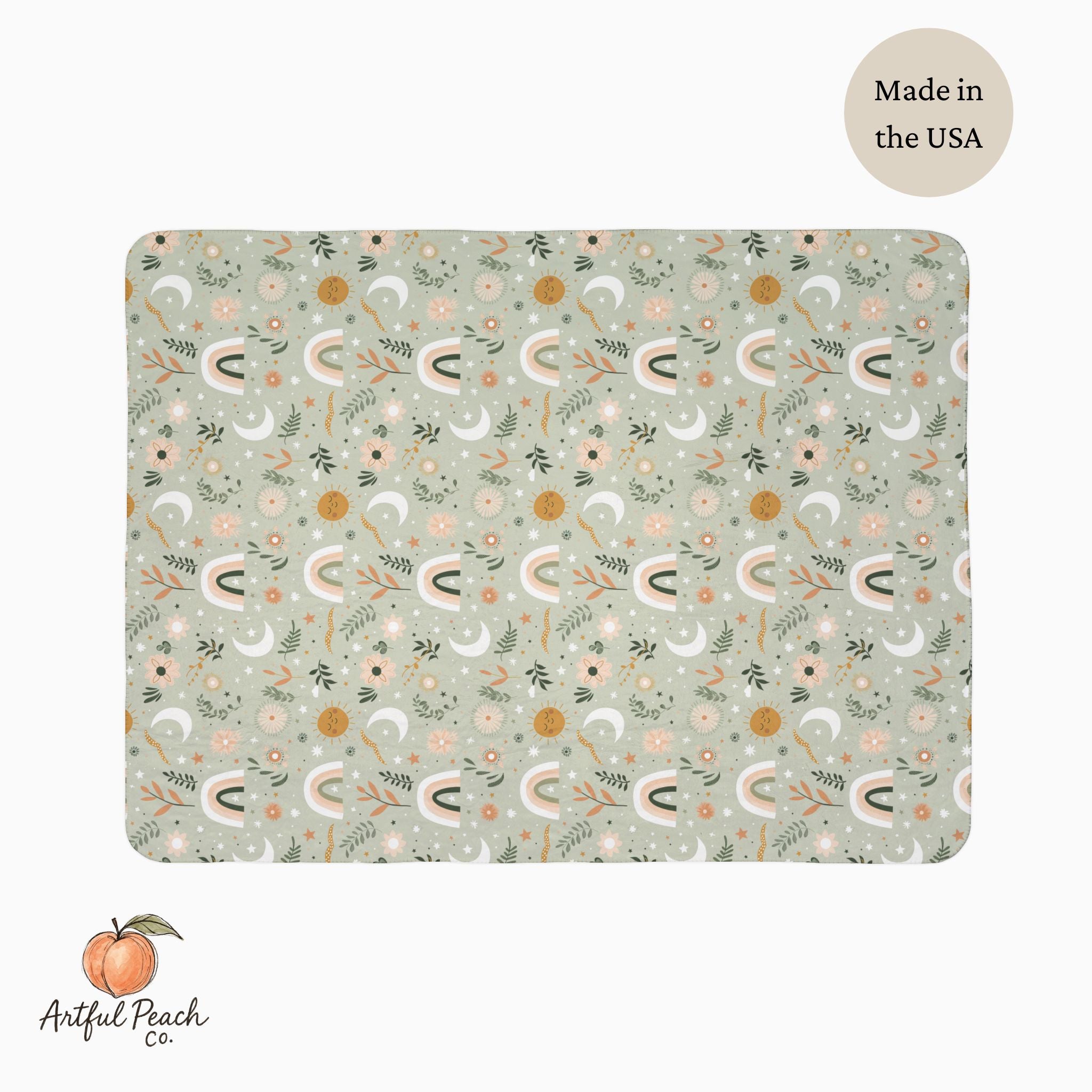 Patterned blanket with 'Artful Peach Co.' branding and 'Made in the USA' label on a light green background.