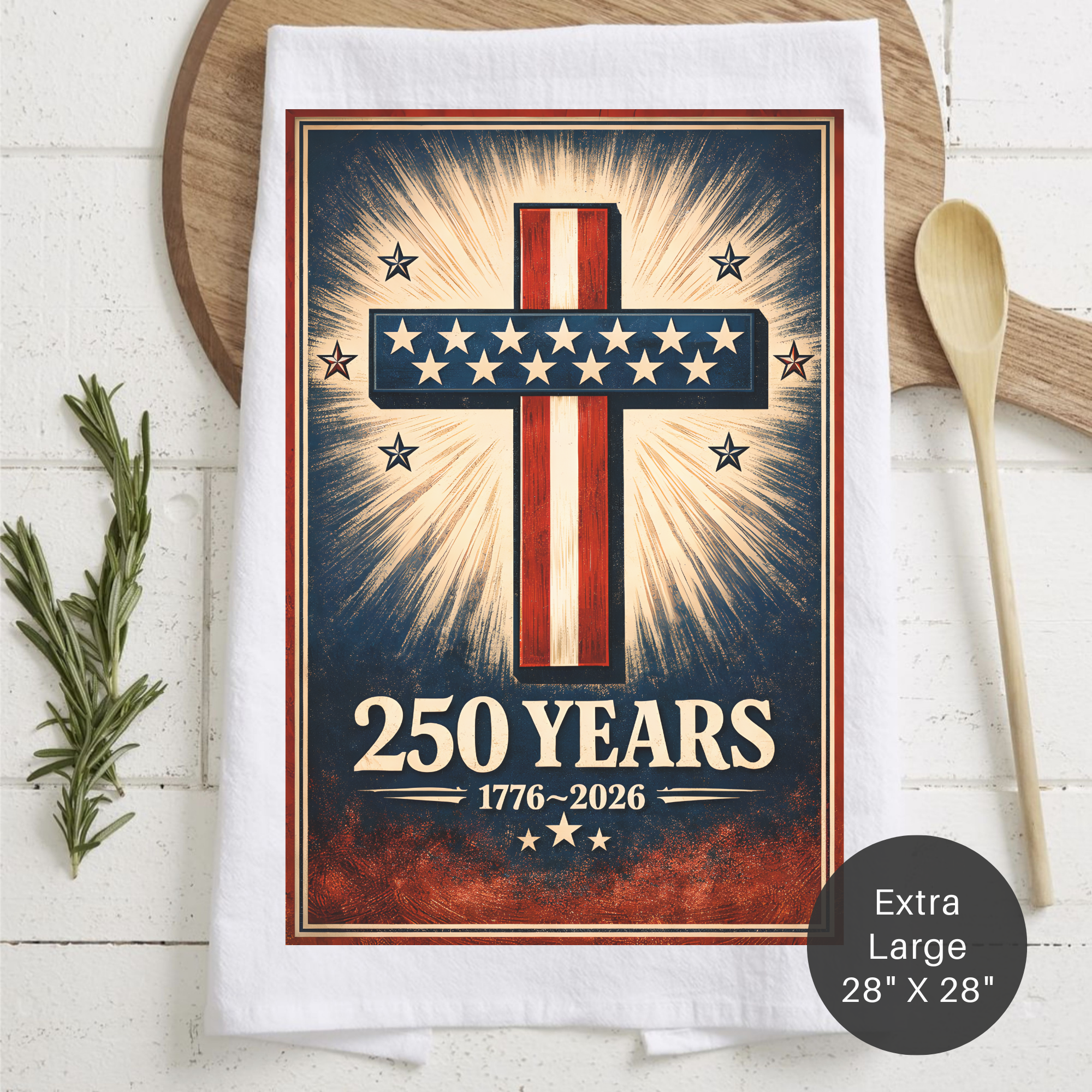Tea towel with a cross design and '250 Years' text on a wooden surface.