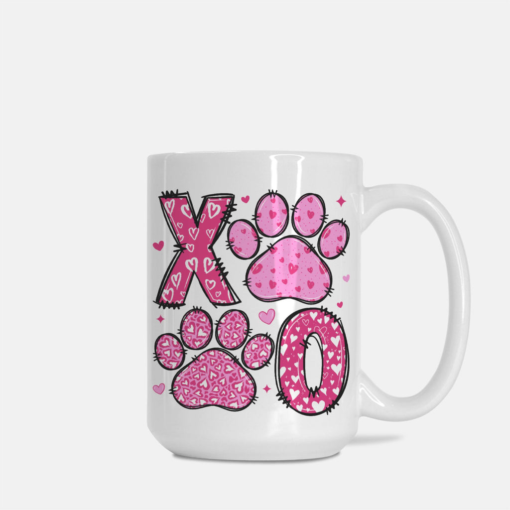 White mug with pink paw prints and heart designs on a white background