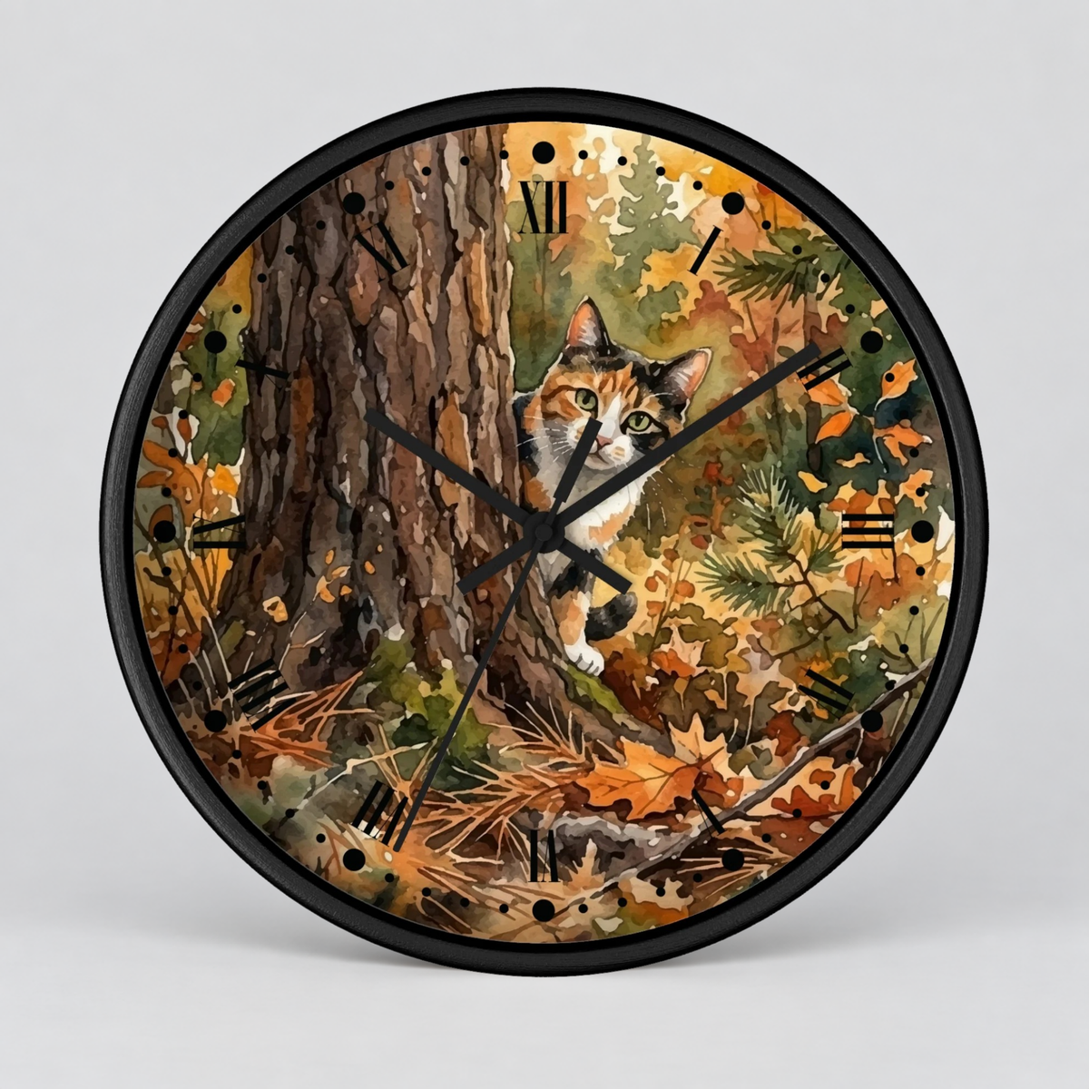 A round wall clock with a black frame and a printed autumn forest scene featuring a calico cat near a tree trunk, shown on a light gray background.