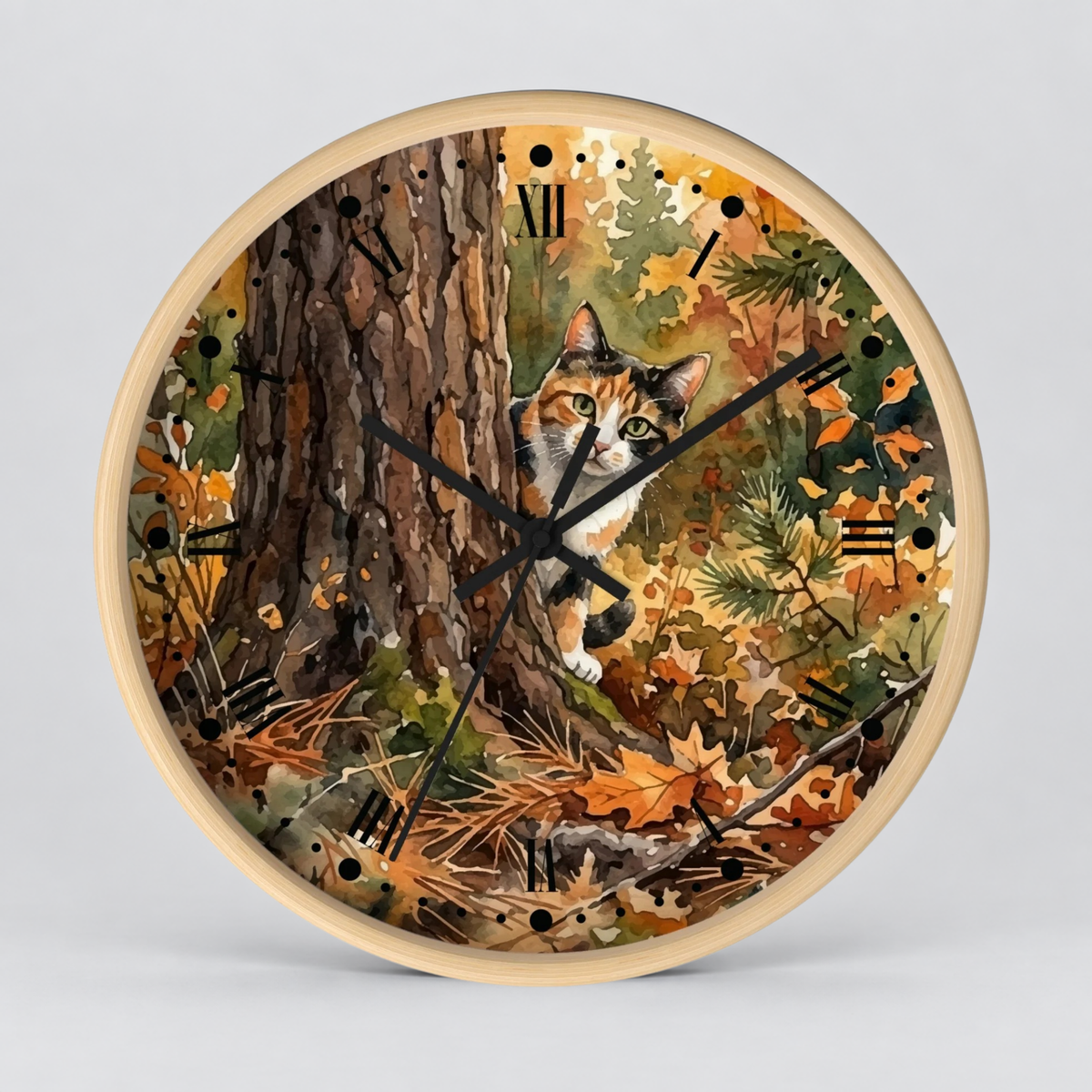 Round wall clock with a light wood frame and a printed autumn forest scene featuring a calico cat peeking from behind  a tree trunk, with black Roman numerals and clock hands on a light gray background.