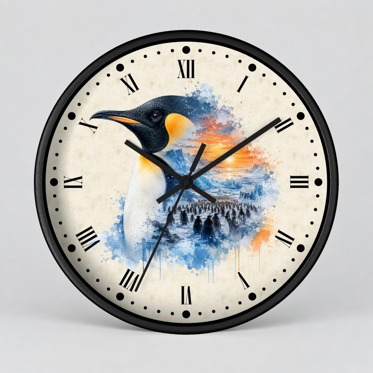 A round wall clock with a black frame and a cream-colored face featuring a watercolor-style penguin illustration in blue, white, black, and orange, with black Roman numerals and hands.