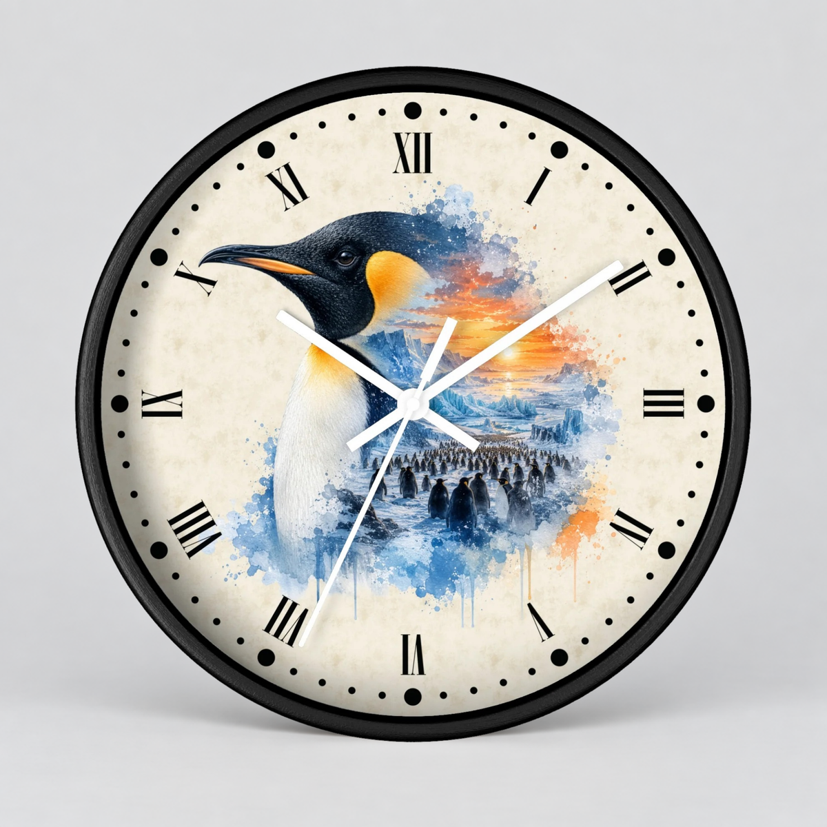 A round wall clock with a black frame and a cream-colored face featuring a watercolor-style penguin illustration in blue, orange, and black tones, with Roman numerals and white clock hands.