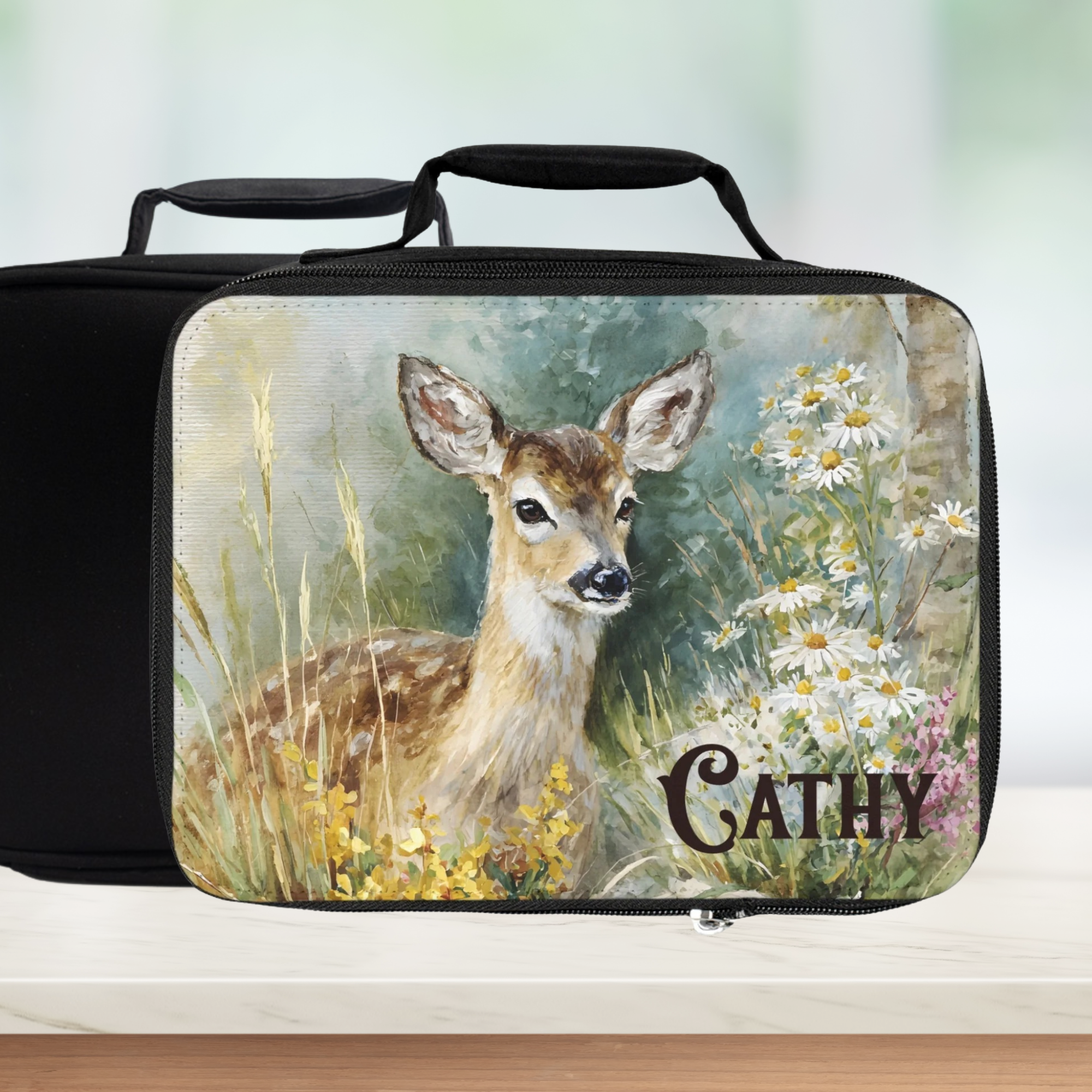 Black lunch bag with a deer design and 'Cathy' custom text on a white background
